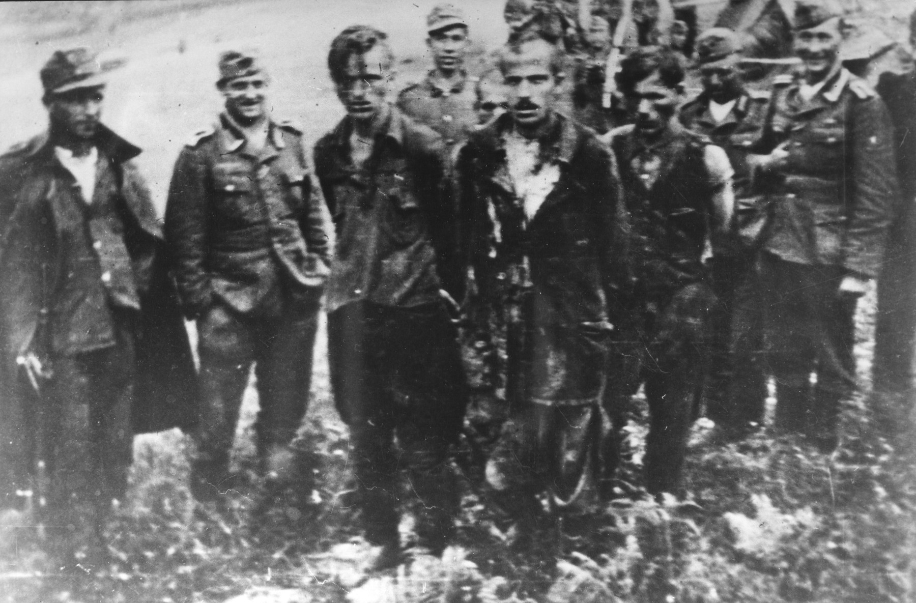 Captured Slovenian partisans are led by soldiers to their execution.