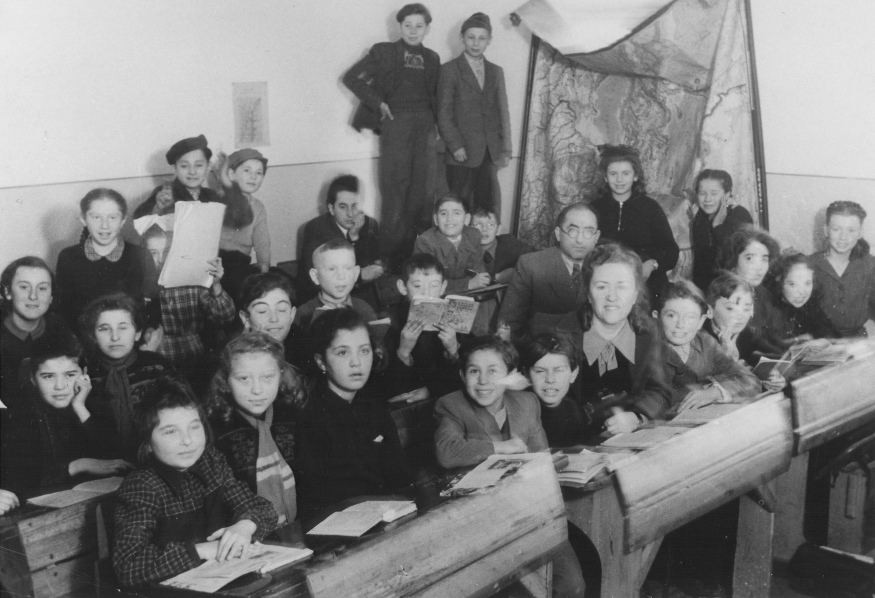 Children sit at their desks in a classroom in the Feldafing displaced persons camp.