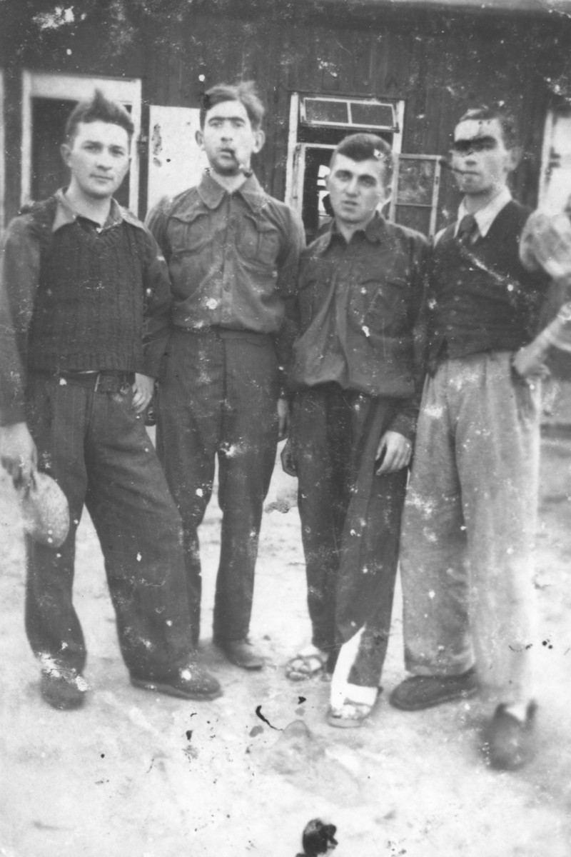 Four Jewish youth pose outside a barracks in the Sdroin labor camp near Ozorkow.

Pictured from left to right are Ignatz Kurek and Jankl Moshe Gornicki.  Gornicki perished in Riga.