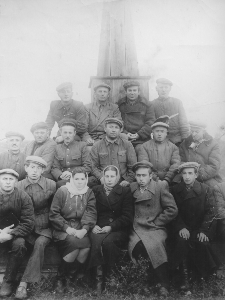 A group of survivors pose in front of a monument which they are constructing in memory of the Holocaust victims of Luboml.