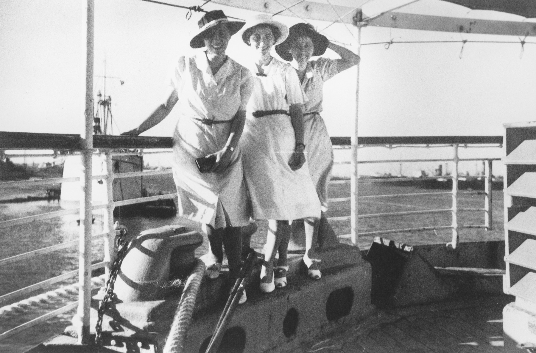 Three Jewish refugee women sail aboard the Usambara to Kenya.

Pictured are Sara, Else and Klara Berg.  Each wears a new hat.  They had each purchased new wardrobes to circumvent the restrictions allowing them to take only ten Reichsmarks out of the country.  Unfortunately, most of their new clothing was stolen at the pier by German dockworkers.