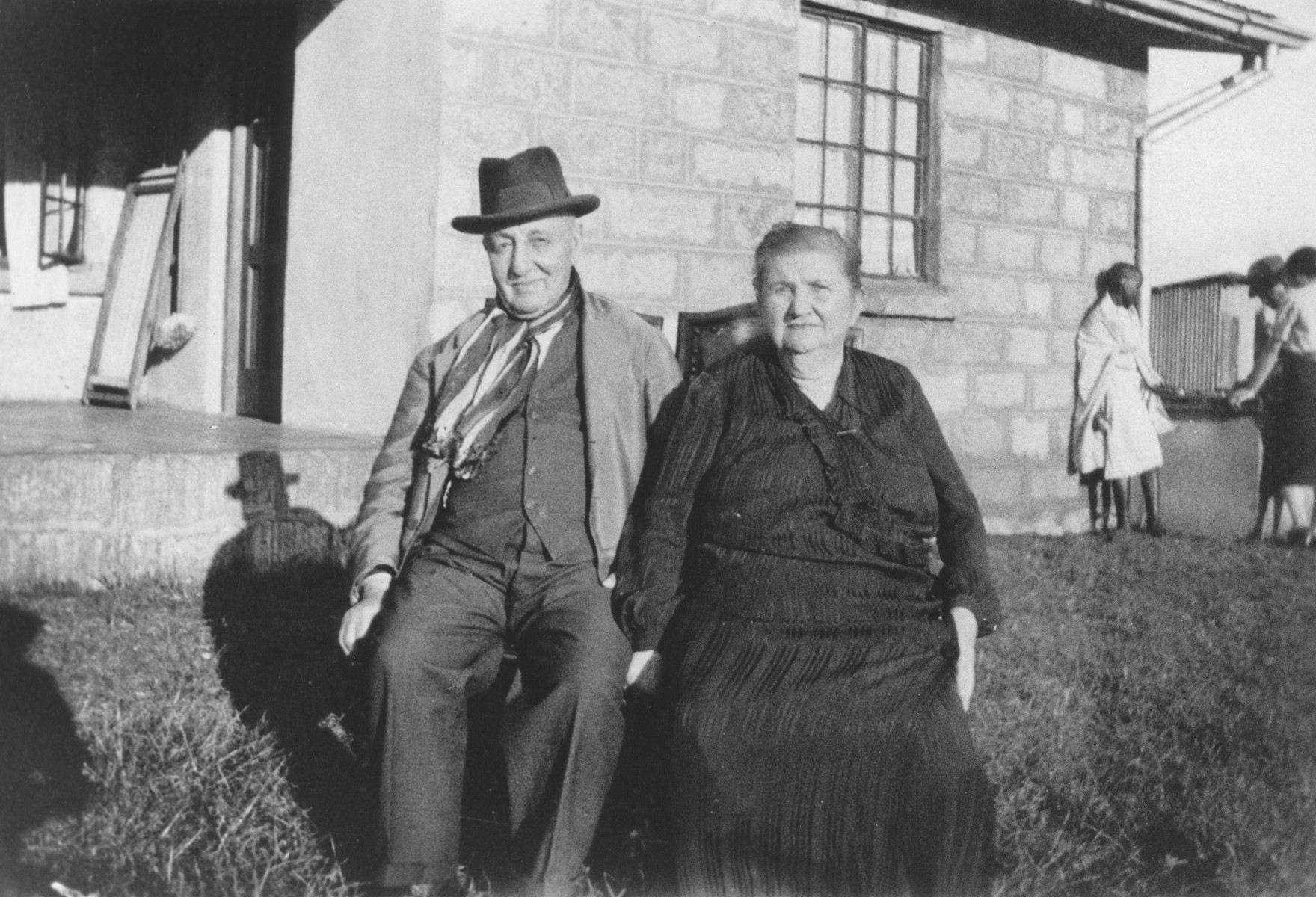 Portrait of a Jewish refugee couple on their farm near Limuru, Kenya (Kiambu district), where they found refuge with their children and grandchildren during World War II.

Pictured are Max and Klara Berg.  Max died in 1942, and Klara, in 1945.  They both were buried in the old Jewish cemetery in Nairobi.
