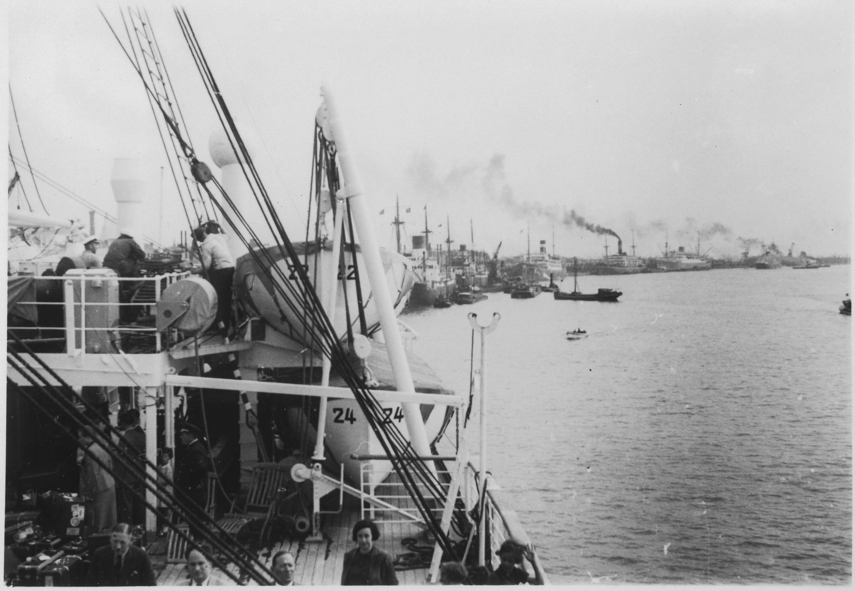 View of ships docked in harbor as seen over the bow of the MS St. Louis.