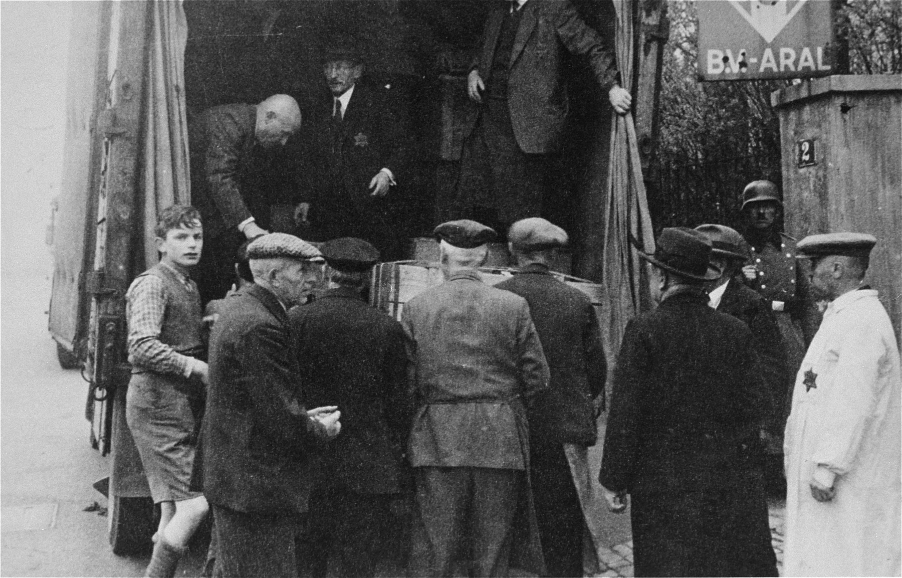 The bundles and suitcases of the Jewish deportees are loaded onto a moving van.