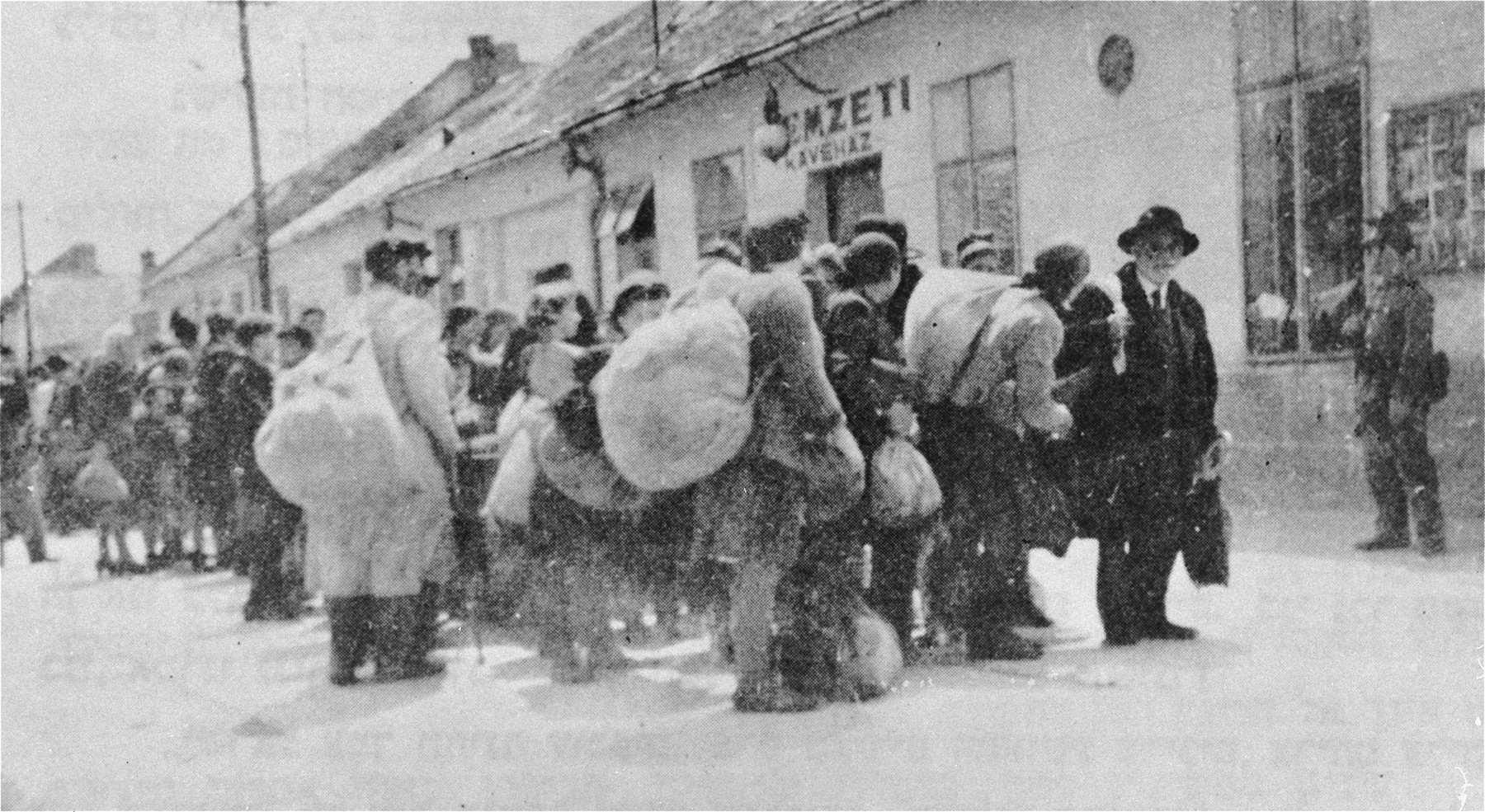 Deportation from Dunaszerdahely [Dunaska Streda].  Jews march along the Obizag Utca [Star Street] on their way to the train station.