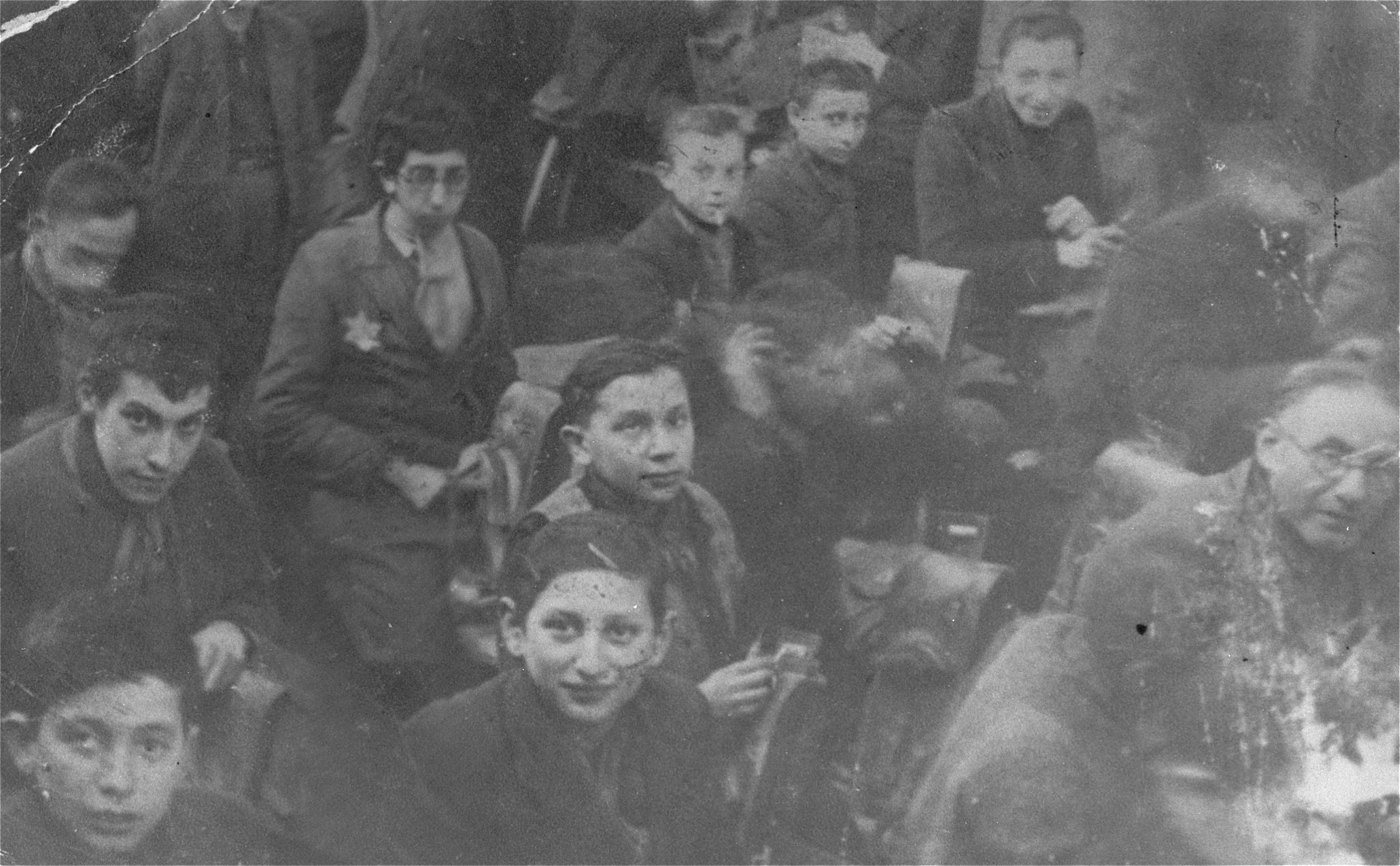 Adults and children work in a harness-making workshop in the Lodz ghetto.

Lajb Majerowicz is pictured in the upper right corner.