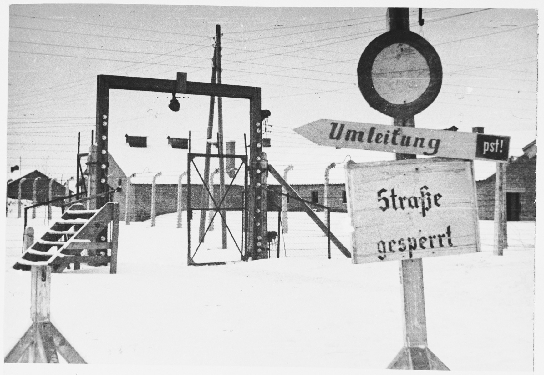 View of one of the gates in the electrified fence surrounding Auschwitz-Birkenau immediately after the liberation.

Original caption:  "One of the entrances in electrified fence."