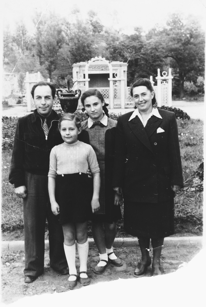 The Pomerants family poses in a park in Vilnius after the war.

From left to right are Daniel Pomerants, Danute, her adopted sister Ruta,  and her mother Lusya.