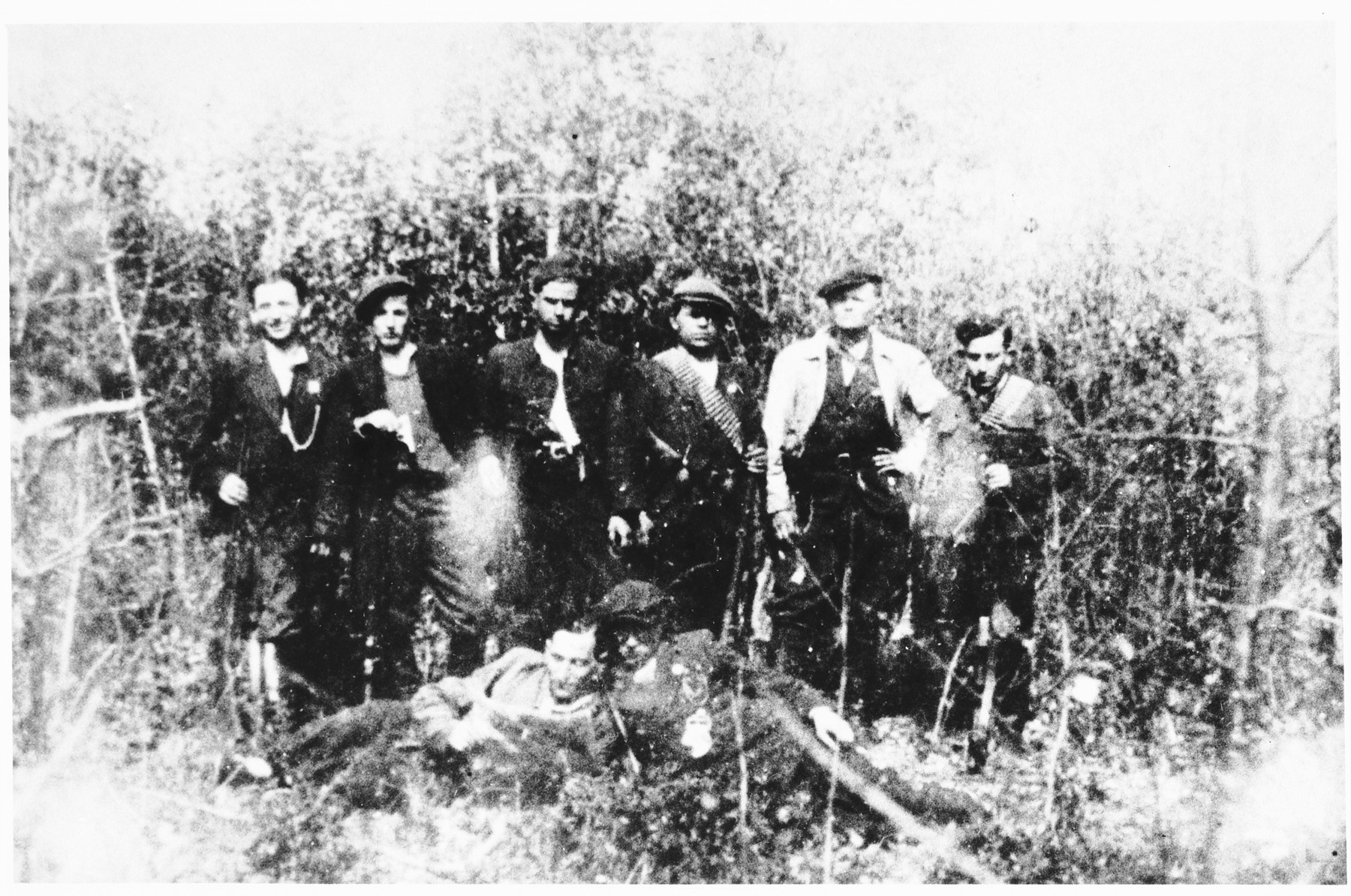 Group portrait of Jewish partisans in the forest.