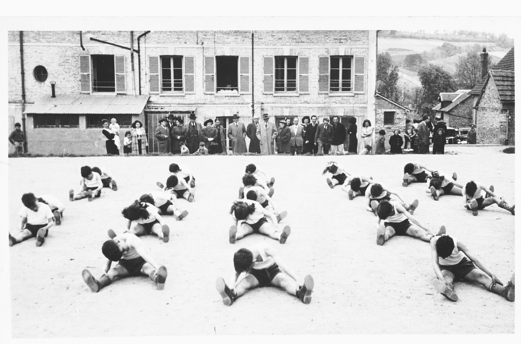 Children exercise in the courtyard outside the Nahum Aronson children's home in Les Andelys, France.