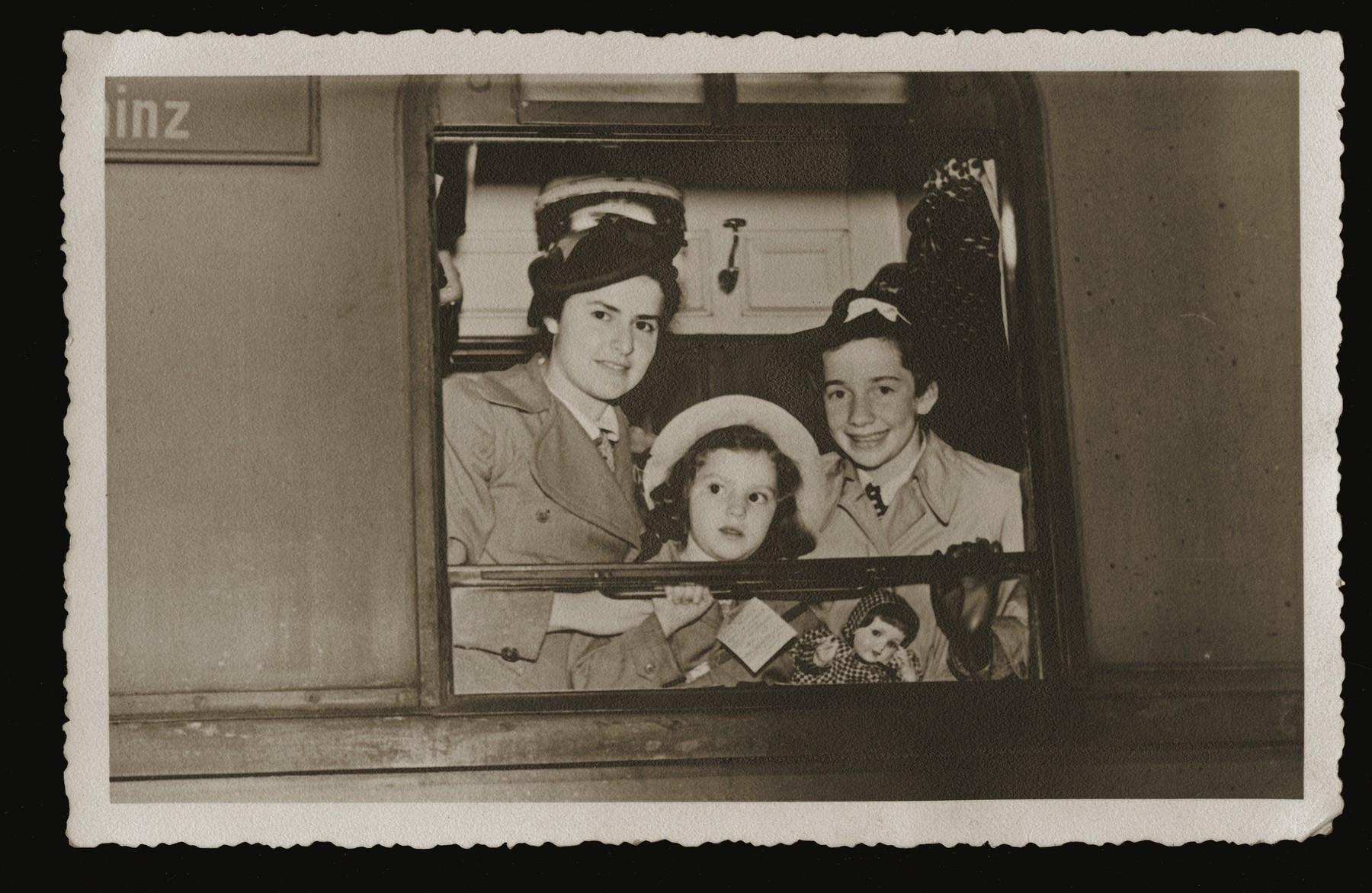 Beate Siegel (right) and two other girls look out a train window as they leave Germany on a Kindertransport to England.