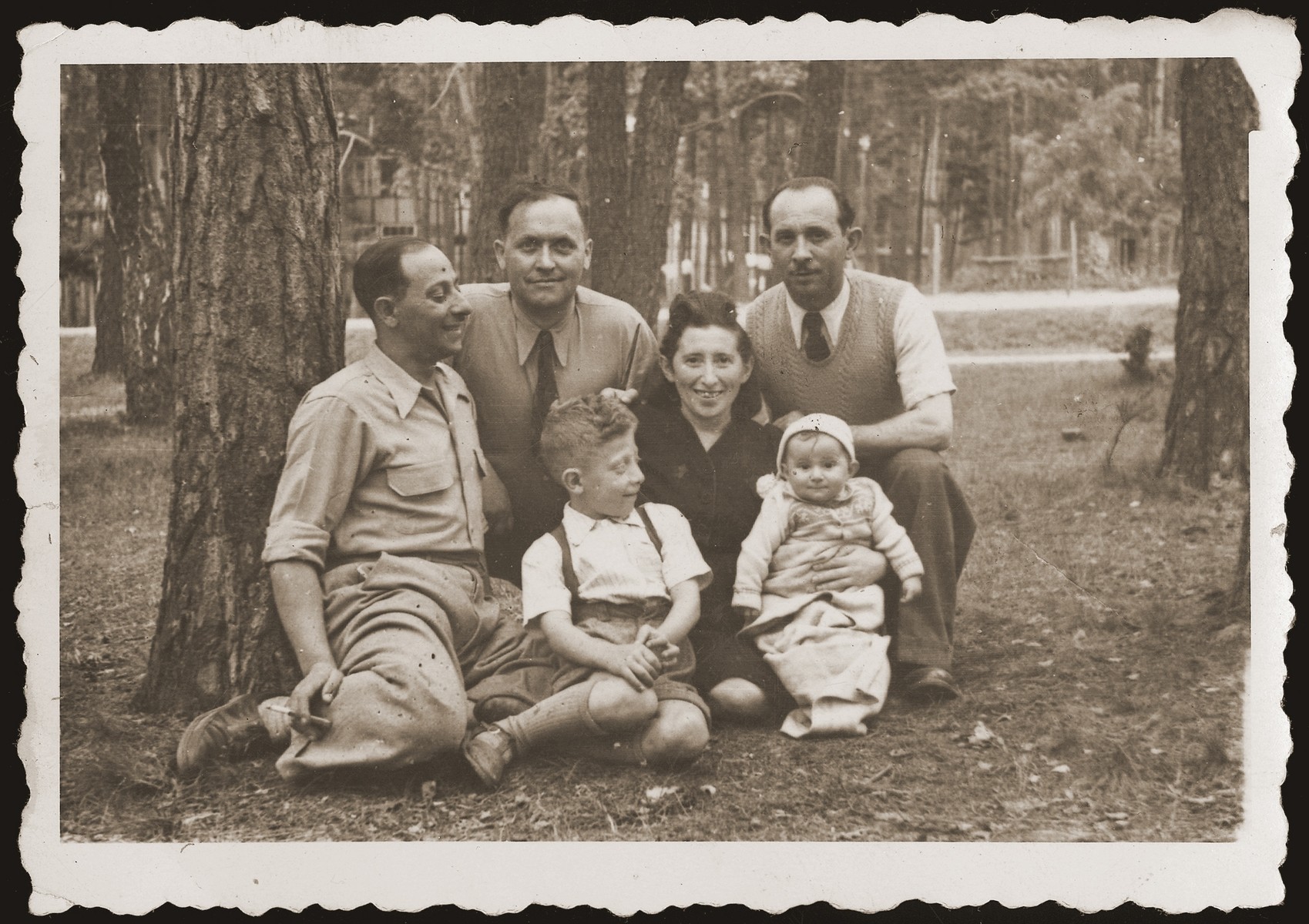 Mania Gryniewicz, seated, with her children, Hania and Adam.  Gutman, her husband, is on the left.  First from right is Victor Jakubowicz, Mania's brother, who visited from Belgium. Second from left is Mosze Stawski, brother-in-law of Kalman Jakubowicz.