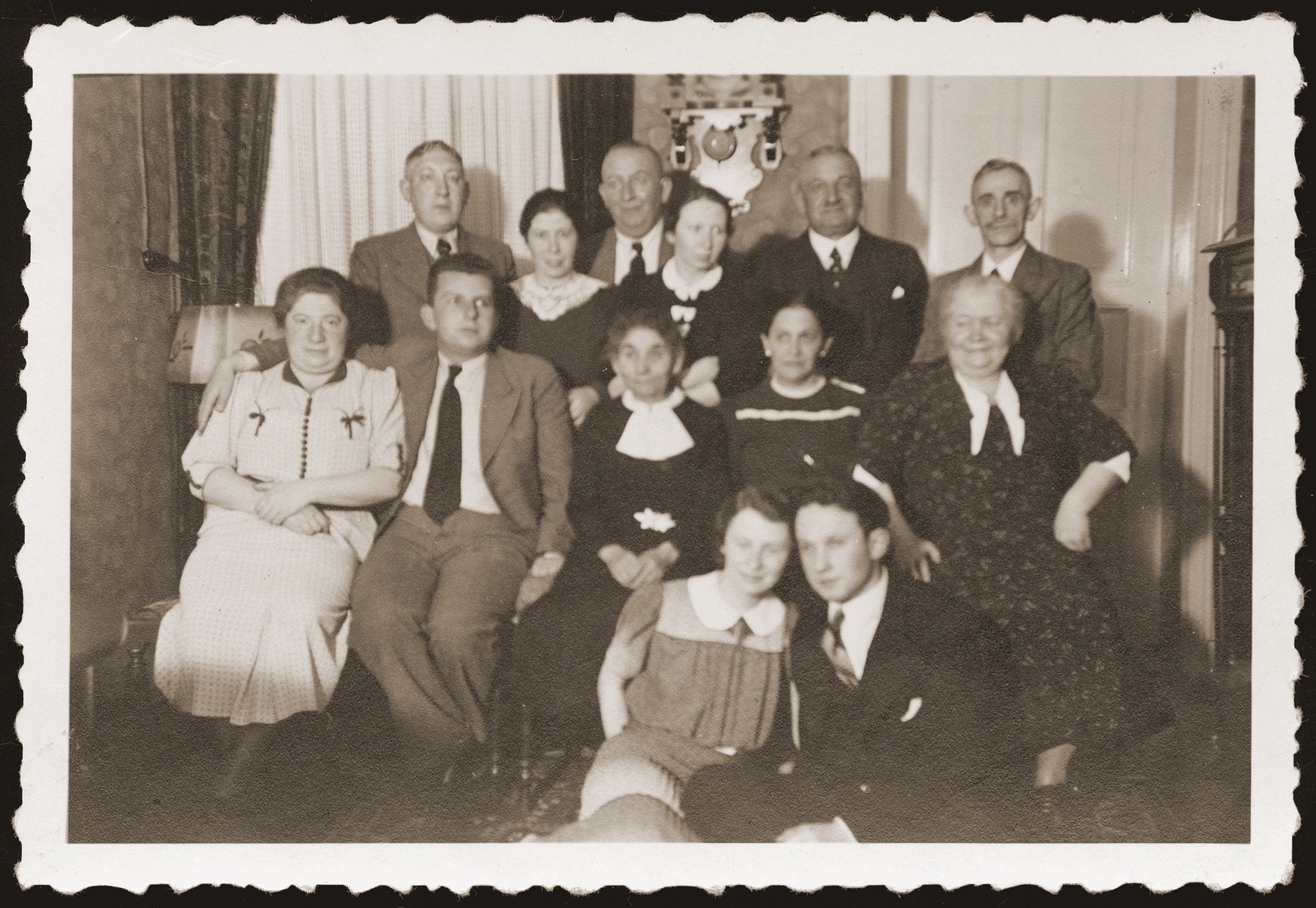 Gera and Alfred Borchart celebrate their engagement with friends and family at the Hettman home.  

Pictured seated second from the left is Walter Jacobsberg.  His father, Siegfried, stands third from the left in the back.

Gera and Alfred Borchart were later deported to the Belzyce ghetto, where they were married on October 29, 1940.  The two perished two years later.
