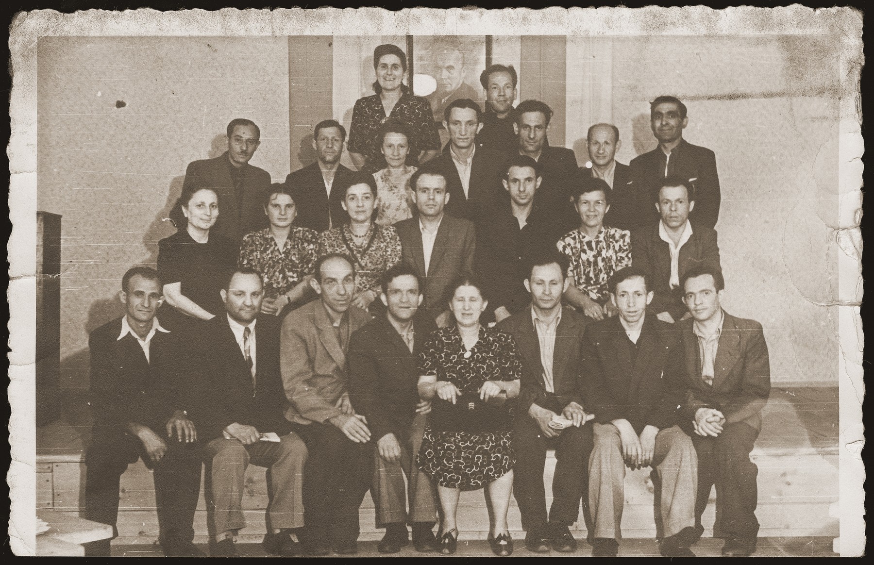 Group portrait of Polish Jews, on a retreat in Srodborow, near Warsaw.  

The portrait on the wall, behind the group is of Boleslaw Bierut, president of Poland.  Standing in the second row, first from left is Mrs. Kiwajko, wife of the editor of "Folks Sztyme", a Jewish daily newspaper in Yiddish.