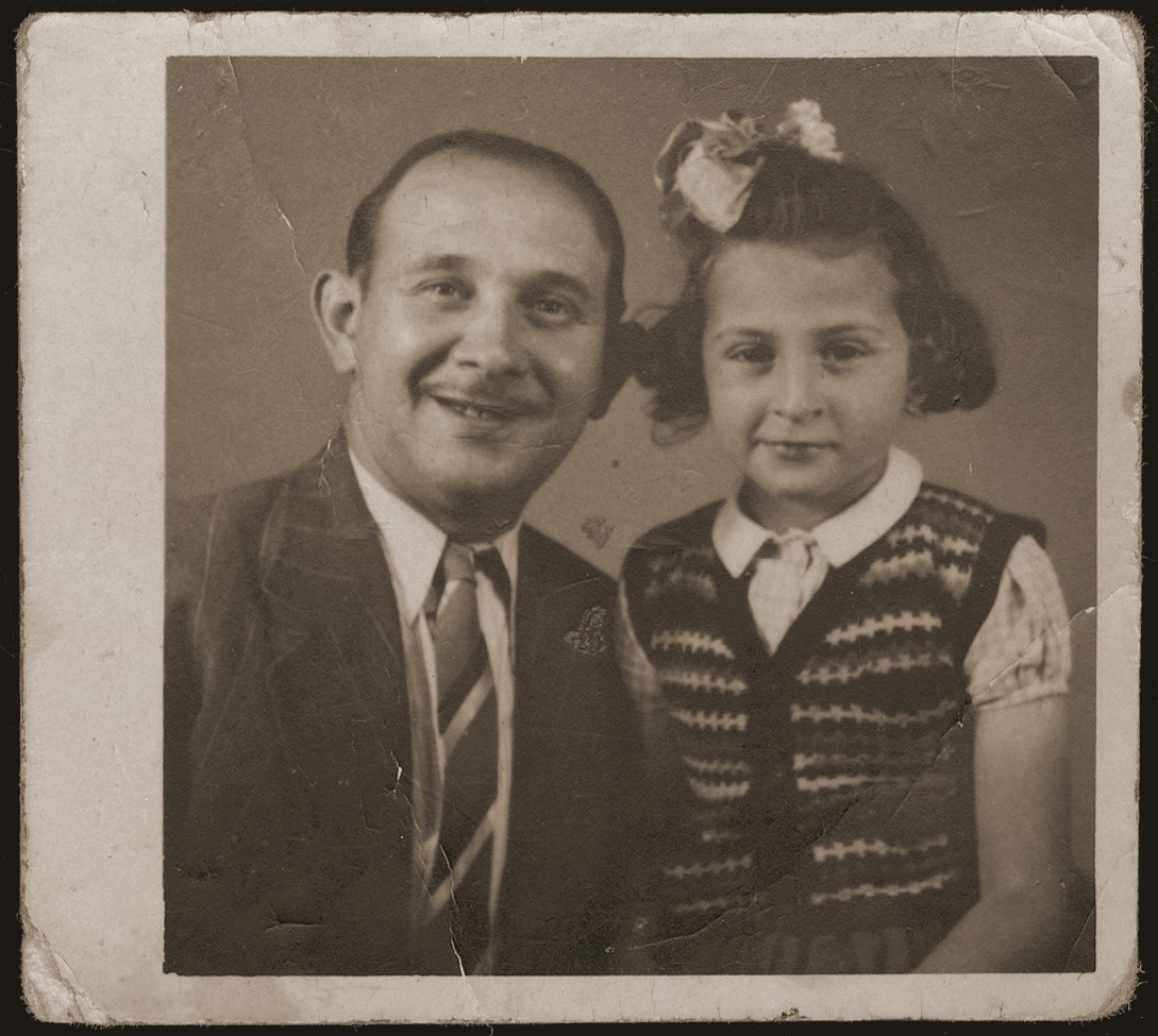 Portrait of Wigdor Wiktor Jakubowicz (donor's brother) and his daughter Rachel Jakubowicz, taken in Brussels, Belgium, upon Wiktor's return from imprisonment in Auschwitz, Buchenwald and Bergen-Belsen concentration camps. 

Rachel survived in hiding, but his wife, Brandla Makufka, was murdered in Auschwitz..