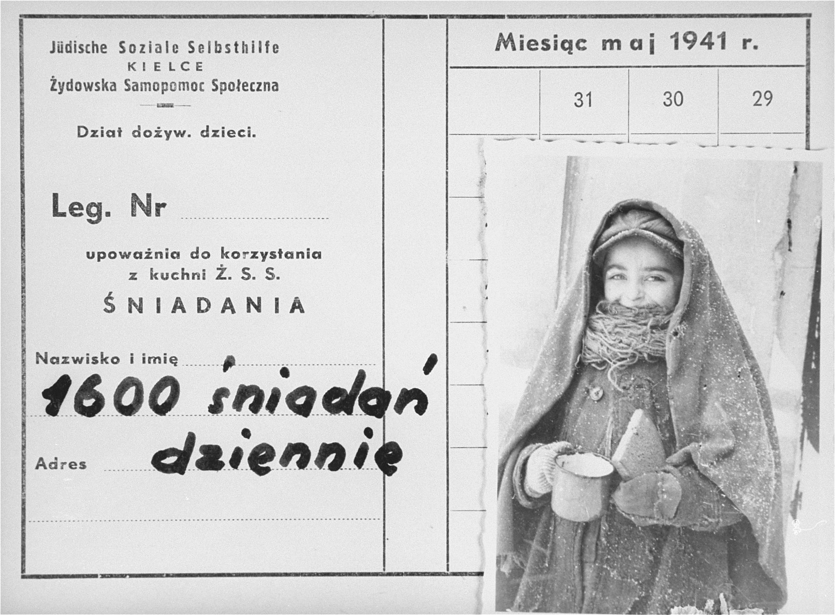 An identification card bearing a photo of a child holding a cup and a piece of bread in the Kielce ghetto. 

An official ID card was required to receive food rations at the soup kitchen organized by the Jewish Social Self-help Committee of the Jewish Council.  The ID card was issued for the month of May 1941, and was valid only for breakfast.  The inscription in Polish reads, "1,600 morning meals served daily."

This photo was one the images included in an official album prepared by the Judenrat of the Kielce ghetto in 1942.