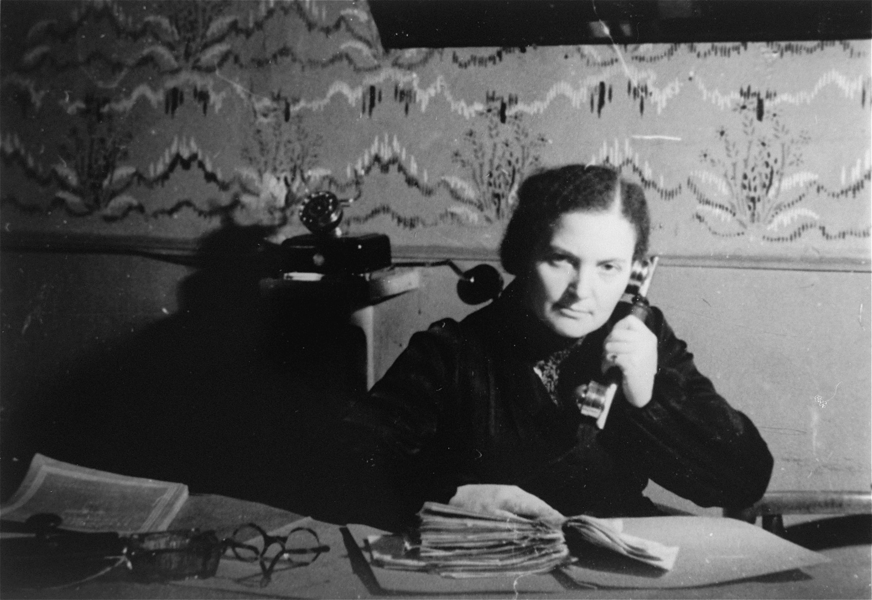 A female member of the ghetto administration sits at a desk in the office of the Judenrat in the Kielce ghetto.

This photo was one the images included in an official album prepared by the Judenrat of the Kielce ghetto in 1942.