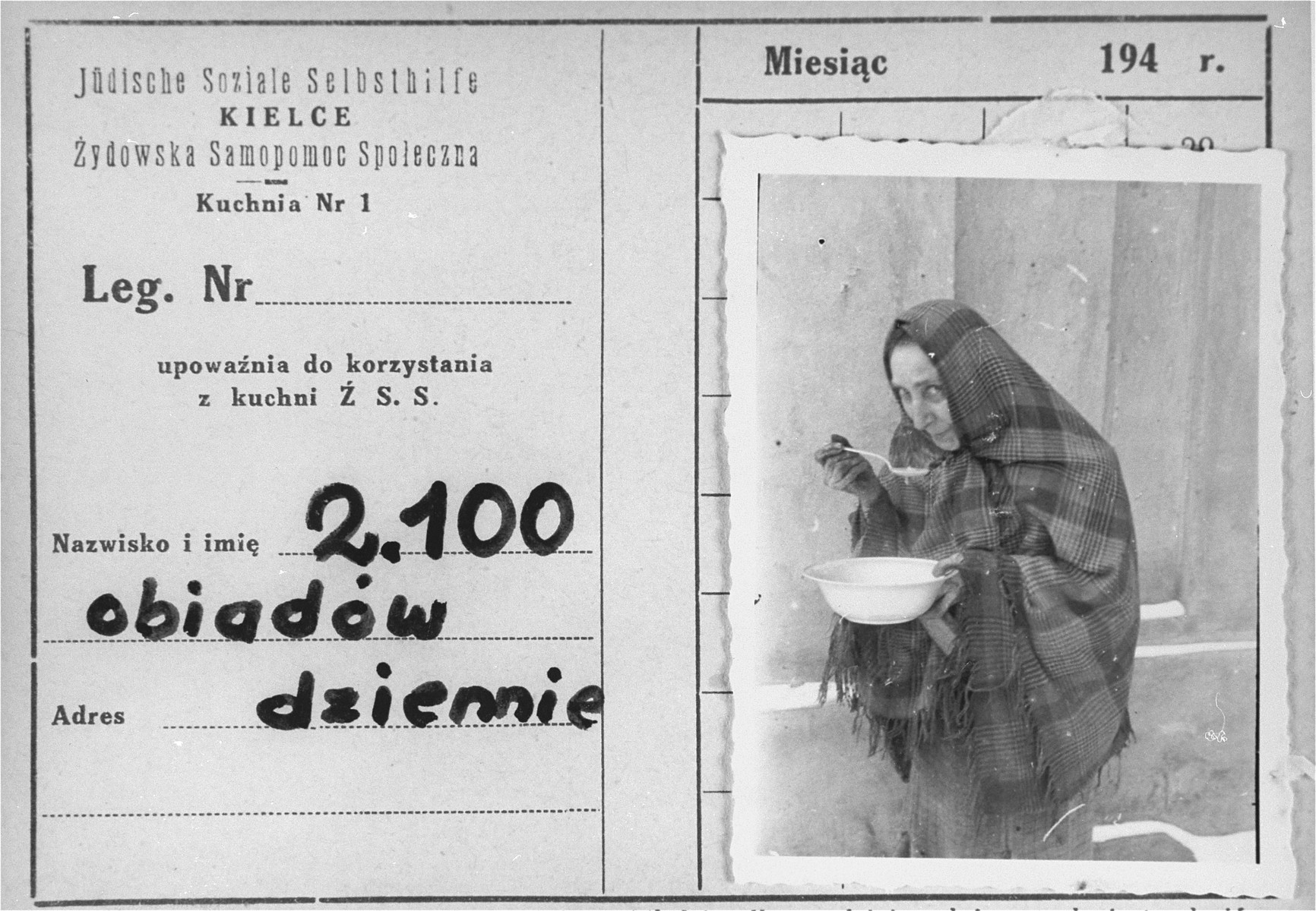 An identification card bearing a photo of a woman eating a bowl of soup in the Kielce ghetto.

An official ID card was required to receive food rations at the soup kitchen organized by the Jewish Social Self-help Committee of the Jewish Council. The inscription in Polish reads: 2,100 dinners served daily.

This photo was one the images included in an official album prepared by the Judenrat of the Kielce ghetto in 1942.