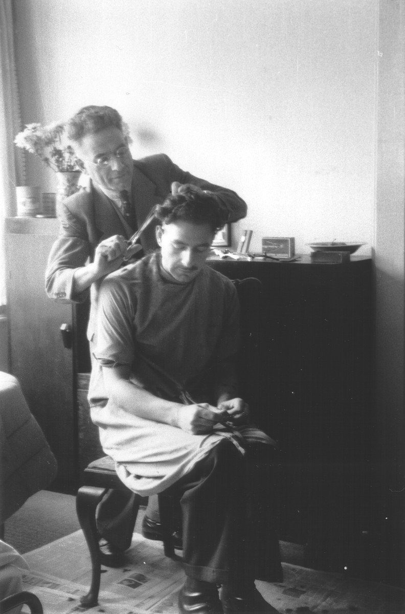 Asser Maurits Aussen gives his son Benno a haircut while in hiding in wartime Amsterdam.