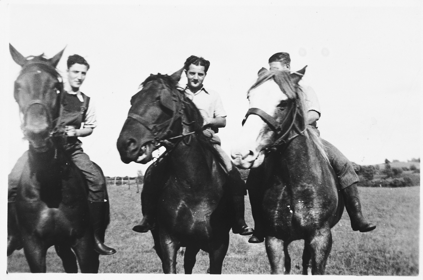 Three young Jewish refugees from Germany ride horses on a farm in the Jutland, where members of their hachshara [Zionist collective] are working.