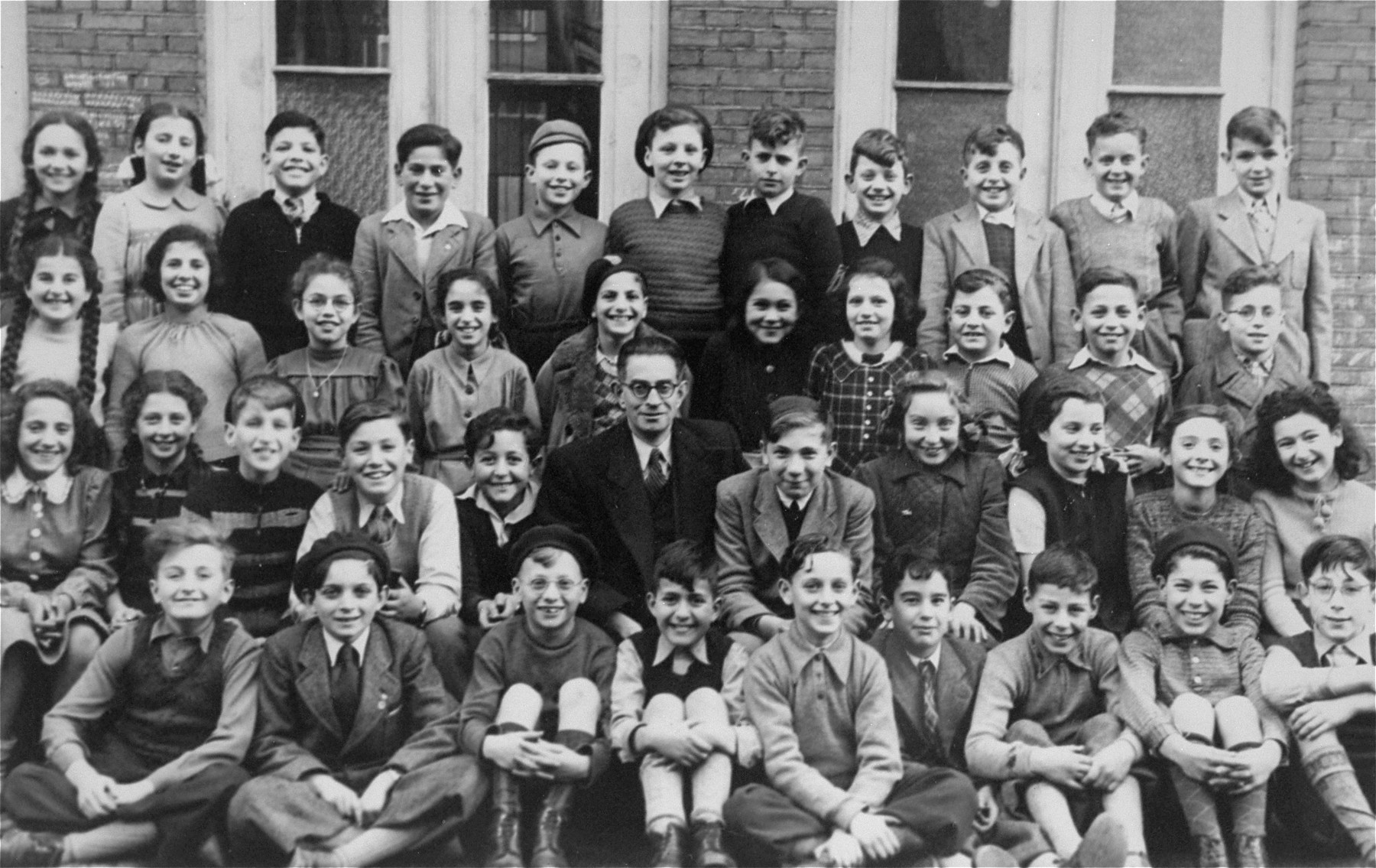 Third grade class at Rosh Pina Hebrew Day School where Marion Kaufmann was a student.  

She is last on the right in the second row from the bottom.  Most of these children left by Kinder Aliyah to Israel.