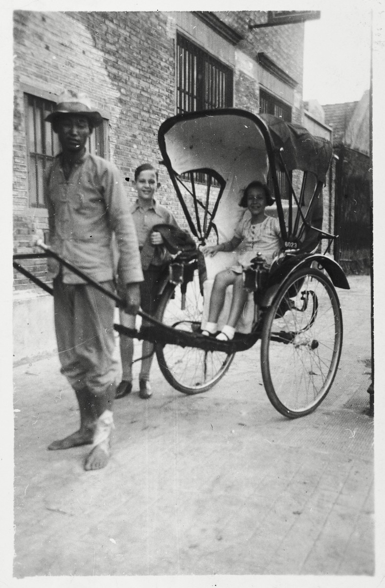 Peter and Marion Witting go for a rickshaw ride on a street in Shanghai.