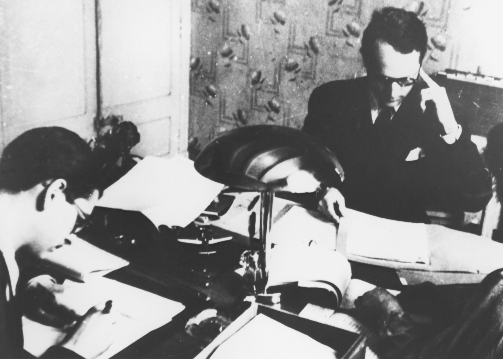 Varian Fry seated at his desk in the offices of the Centre Americain de Secours.