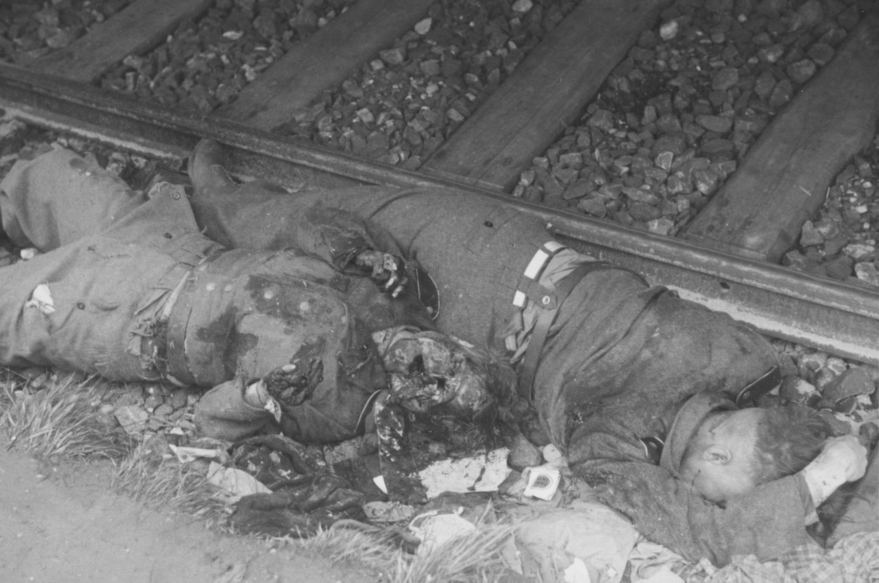 Camp guards, killed in revenge killings, lie next to the railroad tracks in the Dachau concentration camp.