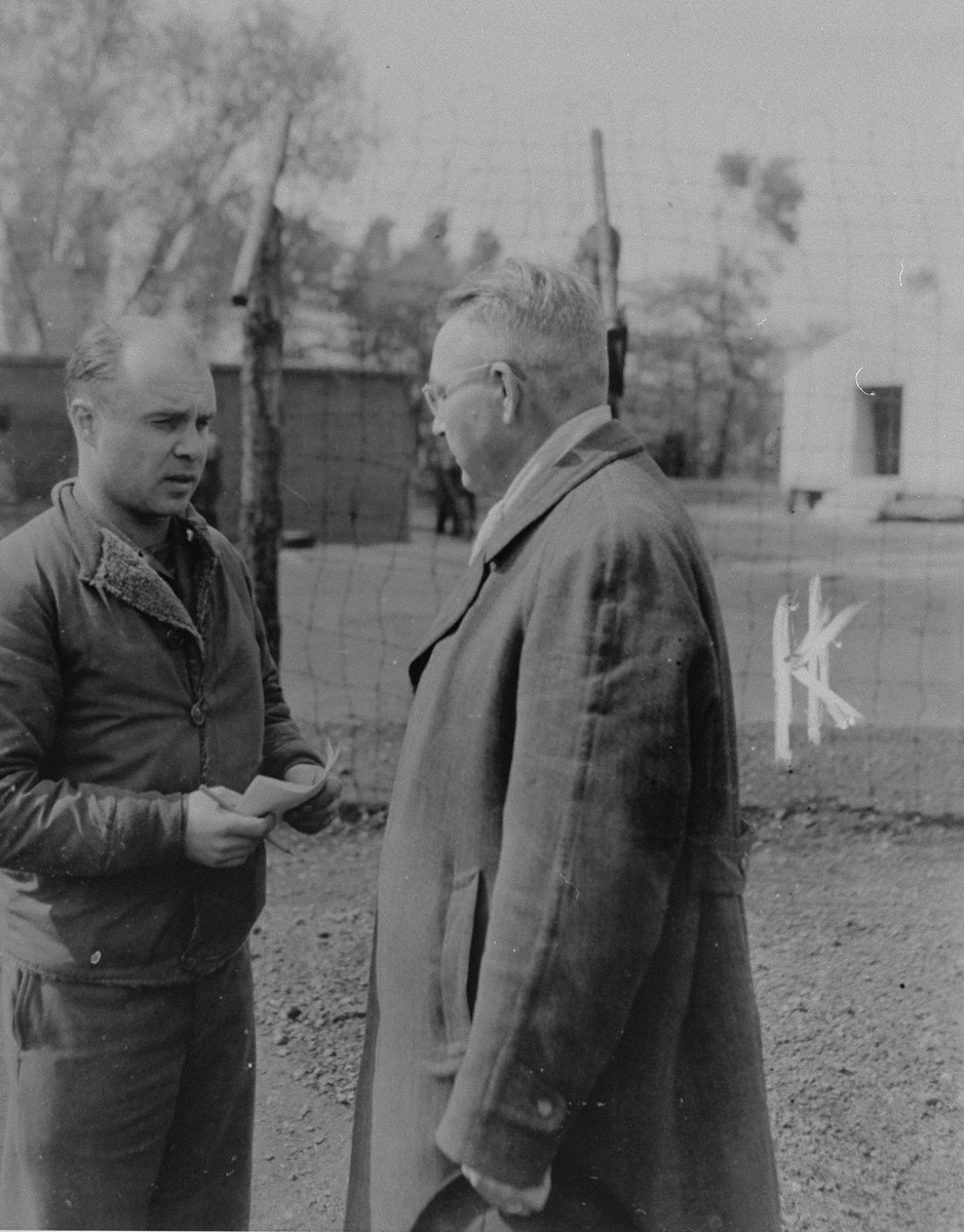 An American investigator from the 79th Infantry Division, U.S. Ninth Army interrogates Dietrich Klagges (right), the former Minister President of Braunschweig and a Lieutenant General in the SS, during his incarceration in the Recklinghausen internment camp.  Klagges was in Recklinghausen while being investigated for his responsibility in the murder of captured American pilots and mistreatment of slave laborers.

When U.S. Ninth Army troops captured the concentration camp for Soviet civilians located near Recklinghausen, Germany, they converted it into a separation center for prisoners of war and war criminals.  After the first German prisoners arrived at the camp they were sent to the interrogation department, which was supervised by Captain Harold Puttfer and Lieutenant H. Goodman.  The camp had three sections called "cages."  One of these was for women, another for persons incarcerated for minor offenses, and the third for hardened criminals.  All three sections were filled to capacity, totalling 20,000 prisoners.