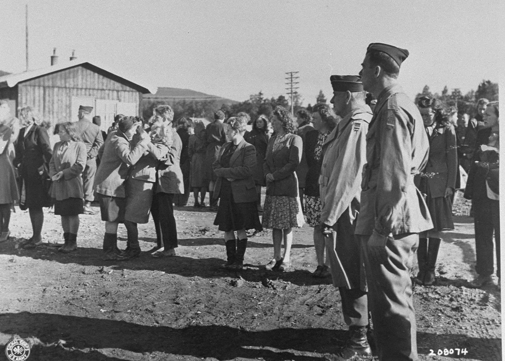 Brigadier General Owen Summers and Colonel Walker look on as Norwegian women suspected of collaborating with the Germans are screened by Allied authorities.