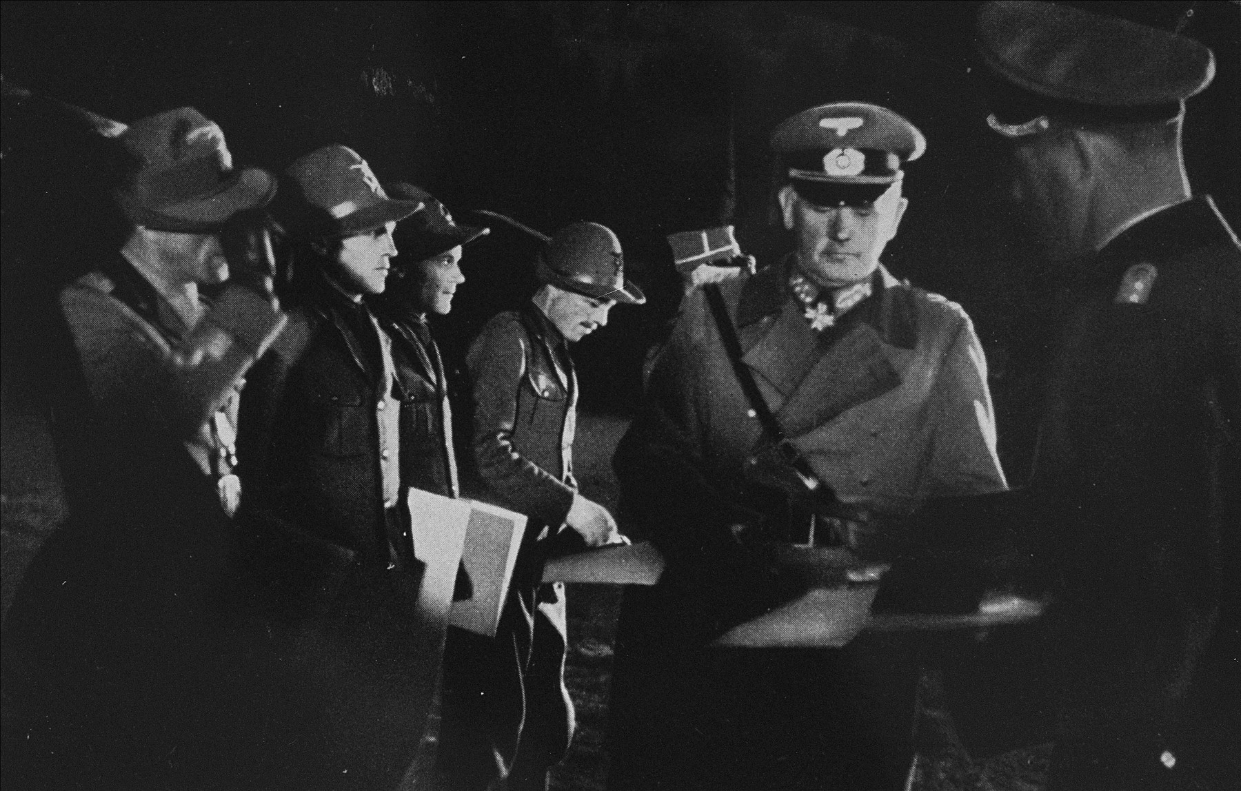 General Werner von Blomberg distributes winners' certificates to an Italian military patrol.  

These certificates were awarded to competitors who participated in exhibition sports during the 1936 Winter Olympics.