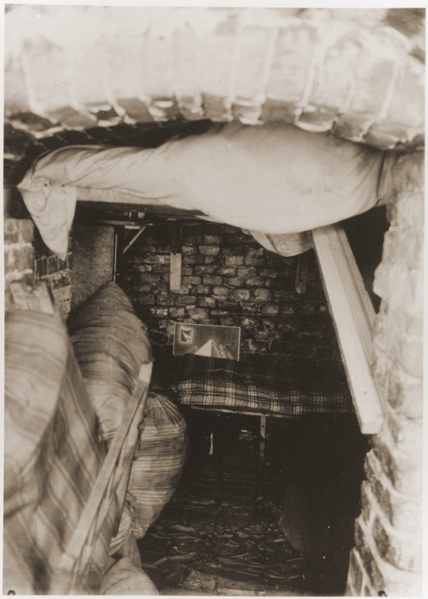 Sleeping quarters in a bunker prepared by the Jewish resistance for the Warsaw ghetto uprising.  The original German caption reads: "Pictures of a so-called residential bunker."