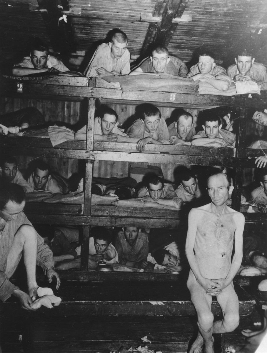 Survivors lie on wooden bunks that are four tiers high, in a barracks in the Buchenwald concentration camp.

The original caption reads, "This photo shows the conditions and the amount of sleeping space for the prisoners at Buchenwald concentration camp. They range from young kids to old men, all donig the same amount of work each day." [sic]

According to the Signal Corps caption, the photo was taken on April 23, 1945.