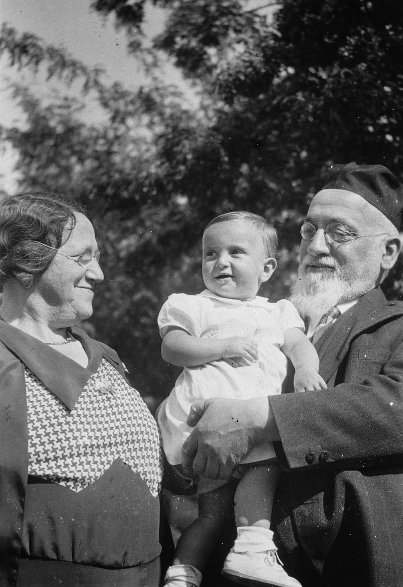 An orthodox Jewish couple poses with their baby granddaughter.

Pictured are Hetty Fisch and her grandparents.