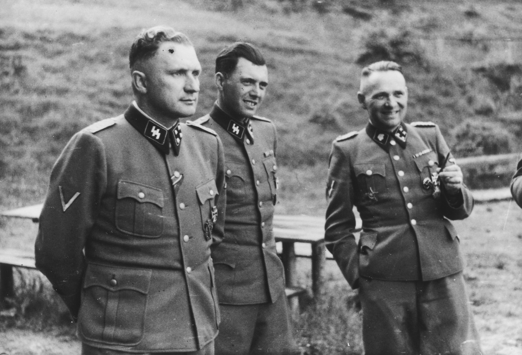 Three SS officers socialize on the grounds of the SS retreat of Solahuette outside of Auschwitz.

From left to right they are: Richard Baer (Commandant of Auschwitz), Dr. Josef Mengele and Rudolf Hoess (the former Auschwitz Commandant). 

[Based on the officers visiting Solahutte, we surmise that the photographs were taken to honor Rudolf Hoess who completed his tenure as garrison senior on July 29.]