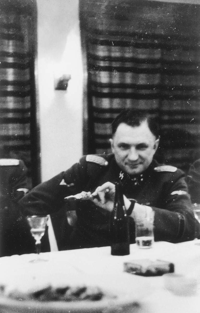 Close-up portrait of SS officer Richard Baer, Commandant of Auschwitz, at the table of a hunting lodge.