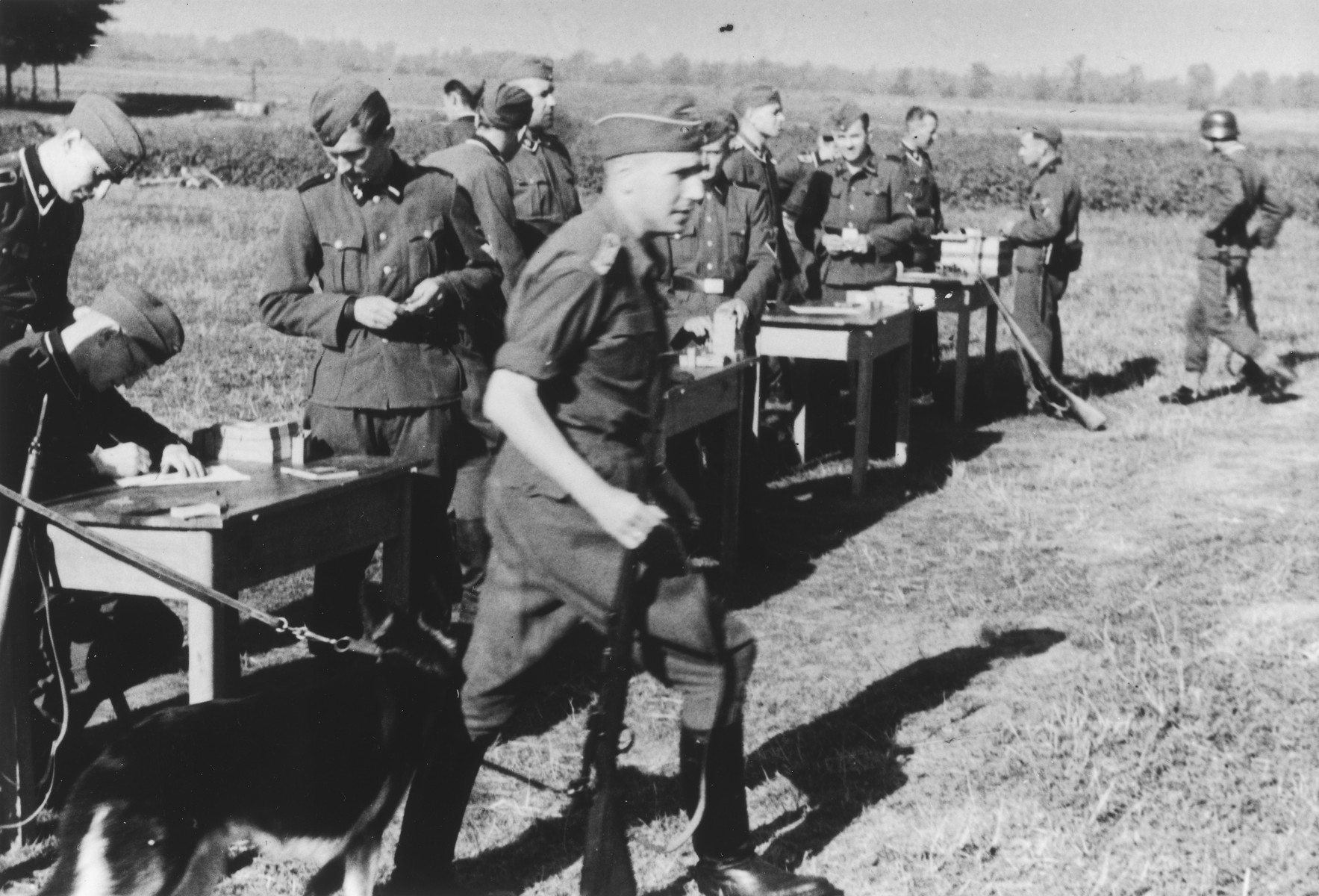 German troops gather for target practice.

Karl Hoecker is in the foreground.

The original caption reads "Der Schuss wurde eine 12" (the shot was a 12).