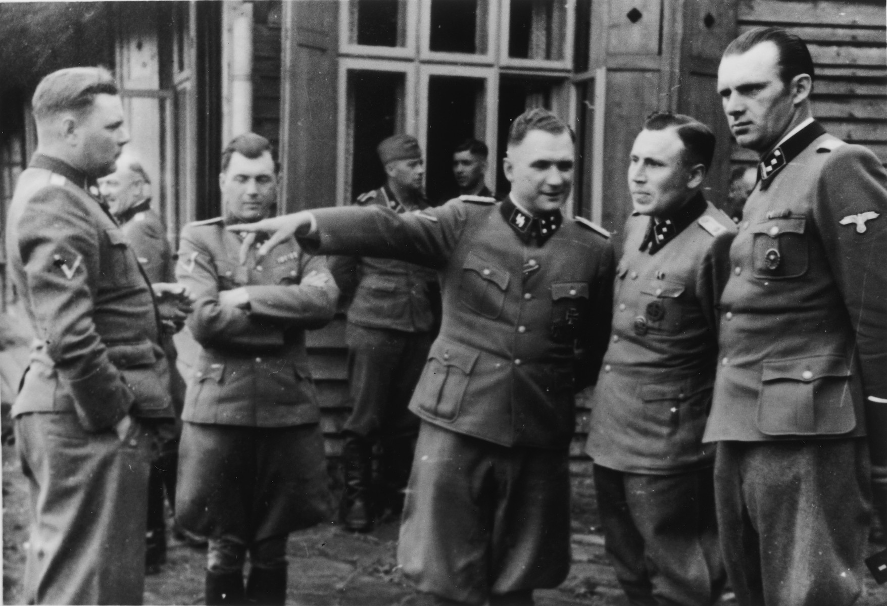 A group of SS officers gathers at Solahuette, the SS retreat outside of Auschwitz.

From left to right are Josef Kramer, Dr. Josef Mengele, Richard Baer, Karl Hoecker and Walter Schmidetzki. 

[Based on the officers visiting Solahutte, we surmise that the photographs were taken to honor Rudolf Hoess who completed his tenure as garrison senior on July 29.]