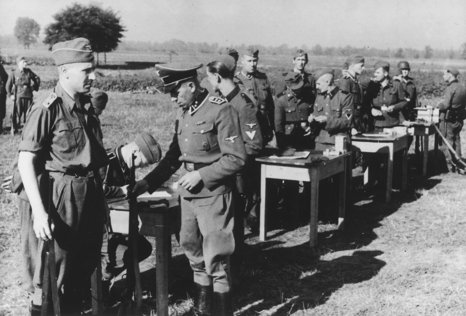 SS officers gather for shooting practice. On the far left is Karl Hoecker.

The original caption reads "Auf dem Schiessstand" (at the firing range).