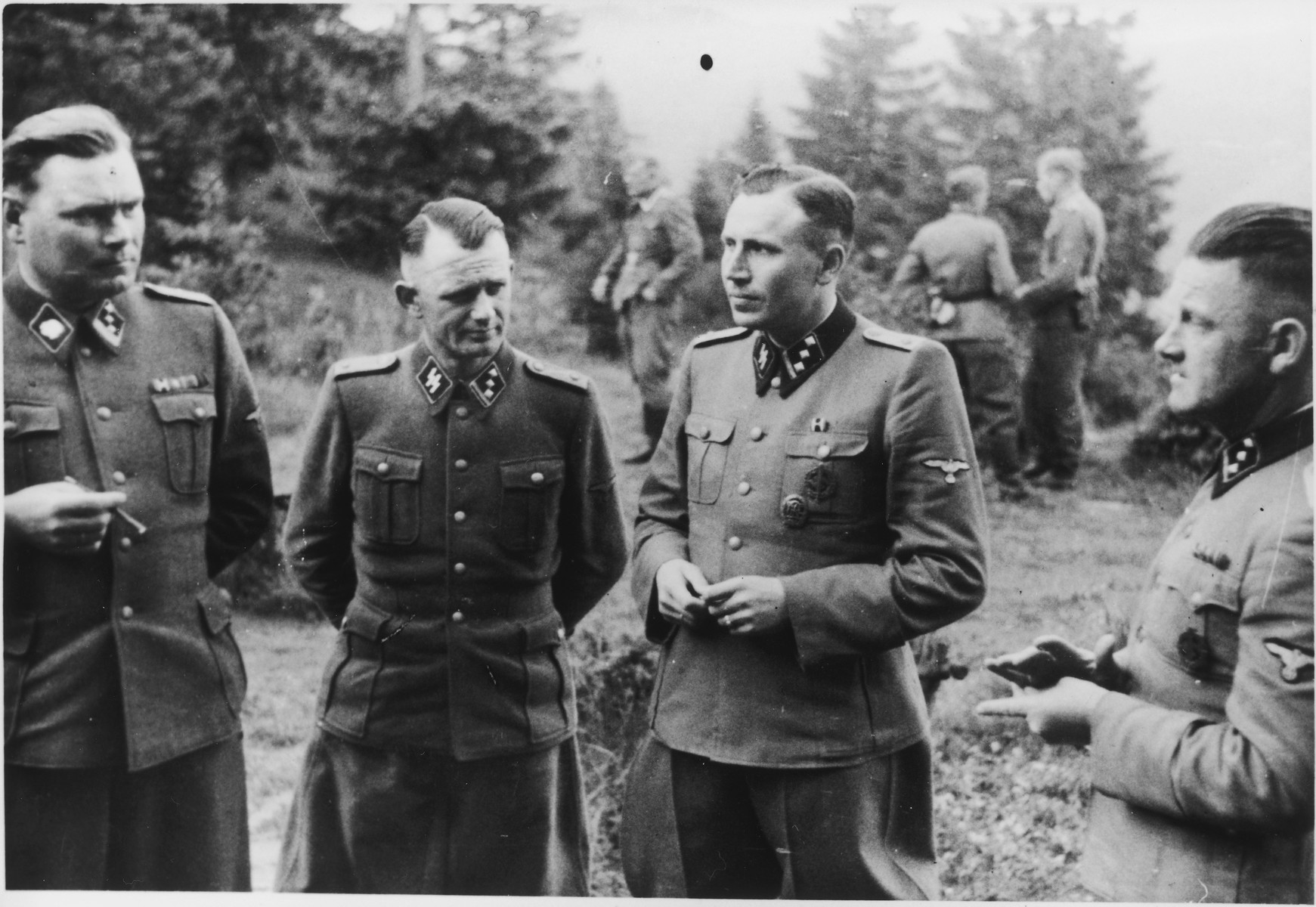 SS officers socialize on the grounds of the SS retreat Solahuette outside of Auschwitz. 

From left to right they are: Josef Kramer, Anton Thumann, Karl Hoecker and Franz Hoessler. 

[Based on the officers visiting Solahutte, we surmise that the photographs were taken to honor Rudolf Hoess who completed his tenure as garrison senior on July 29.]