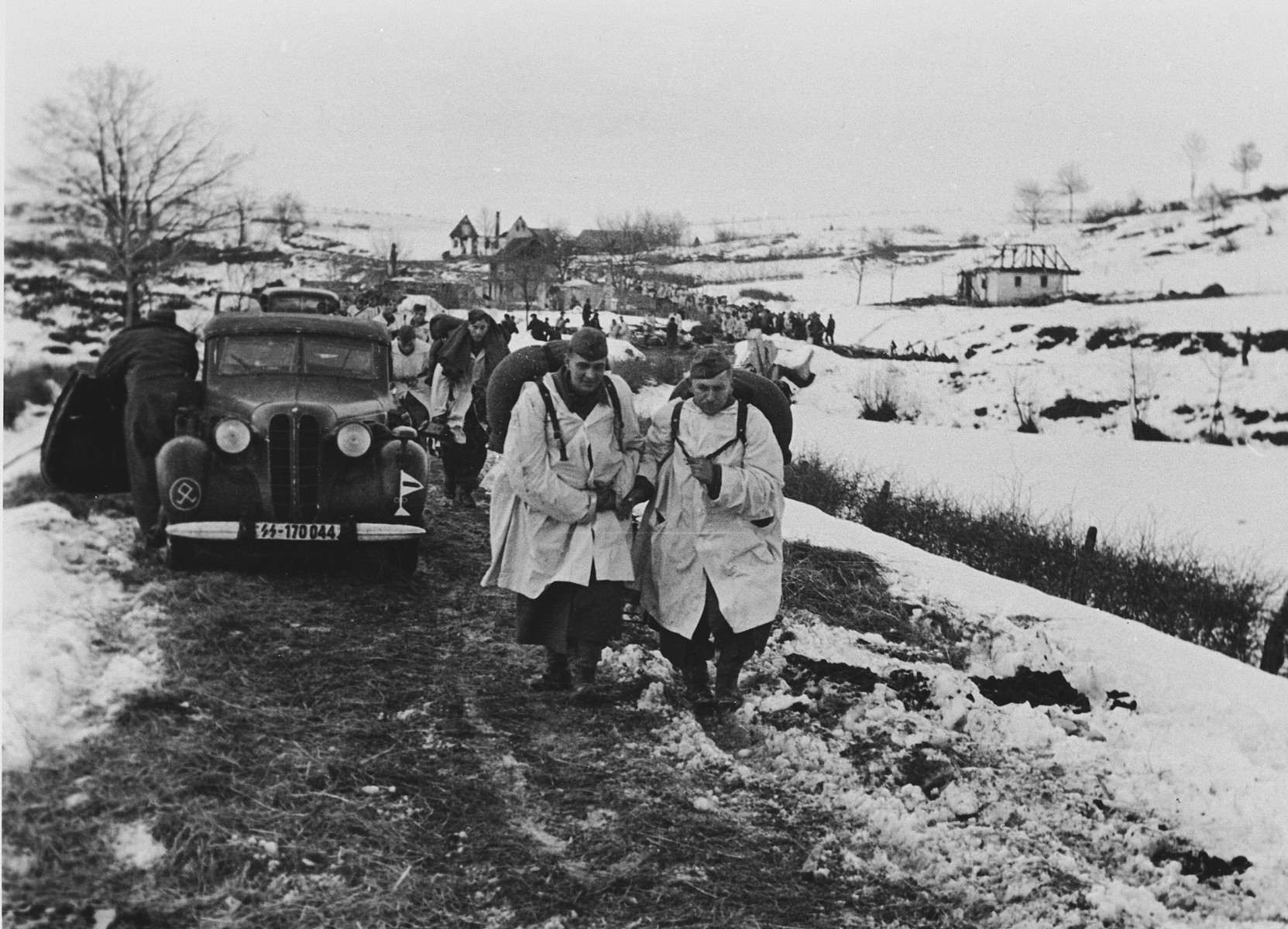 Members of the "Prinz Eugen" Division march down a road near the town of Grahovo, Croatia.

The original caption (translated) reads, "Tanks are brought into action against the enemy in Grahowo."

One of a series of photographs taken by the 7th SS Volunteer Mountain Division Prinz Eugen in Croatia, Serbia, and Montenegro from 1942 to 1944, after the German invasion of the Kingdom of Yugoslavia. The photographs are believed to have been captioned by the commanding office of the Waffen-SS, and had been in the possession of  Friedrich Wilhem Krueger, who served with the division from November 1943 until April 1944.