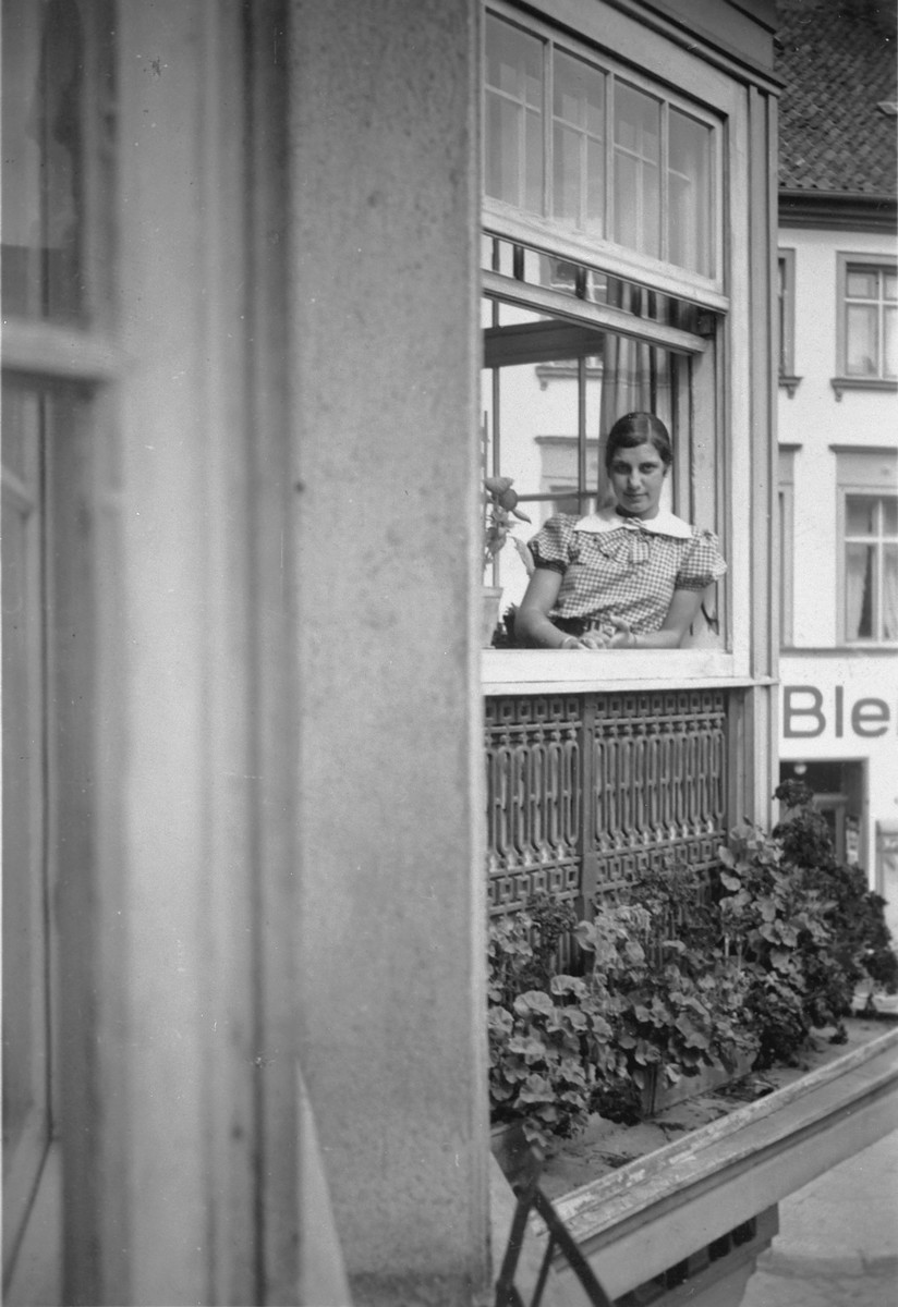 A German-Jewish teenage girl looks out the window of her home.

Pictured is Hildegard Wolff.