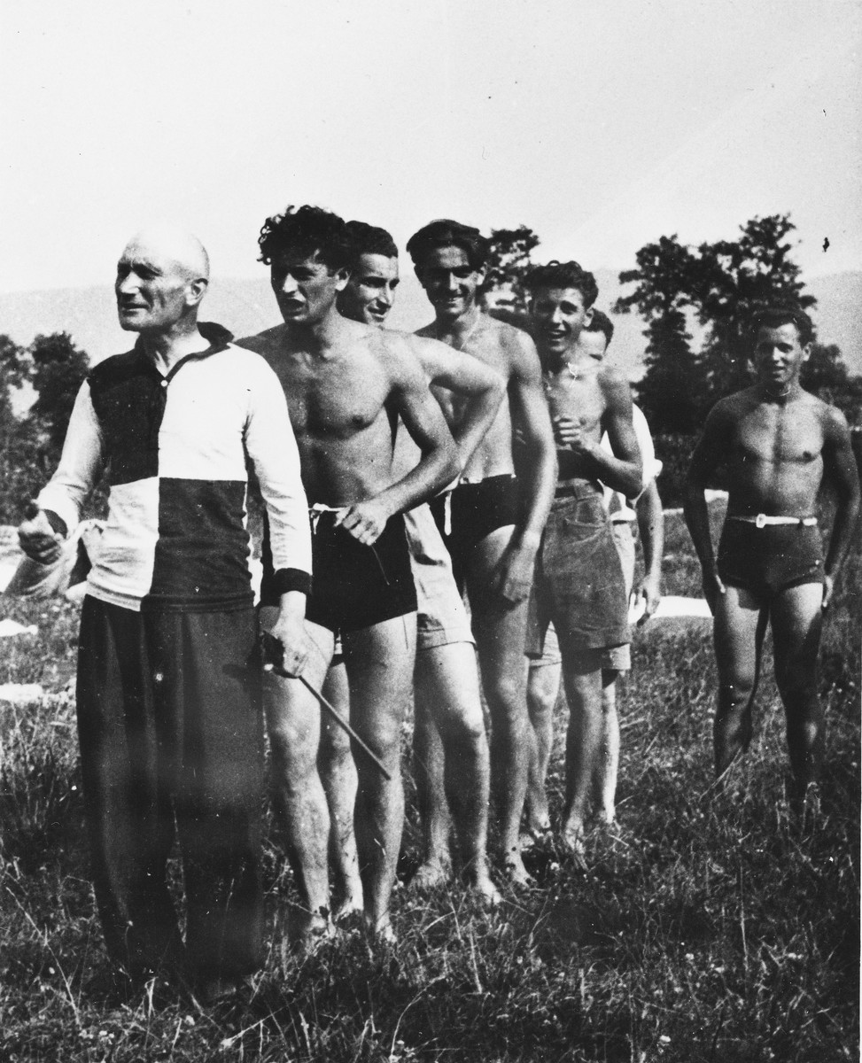 [Prisoners from the Sixth Labor Battalion, dressed in swim suits and shorts, participate in athletic activities at a Slovak labor camp.]