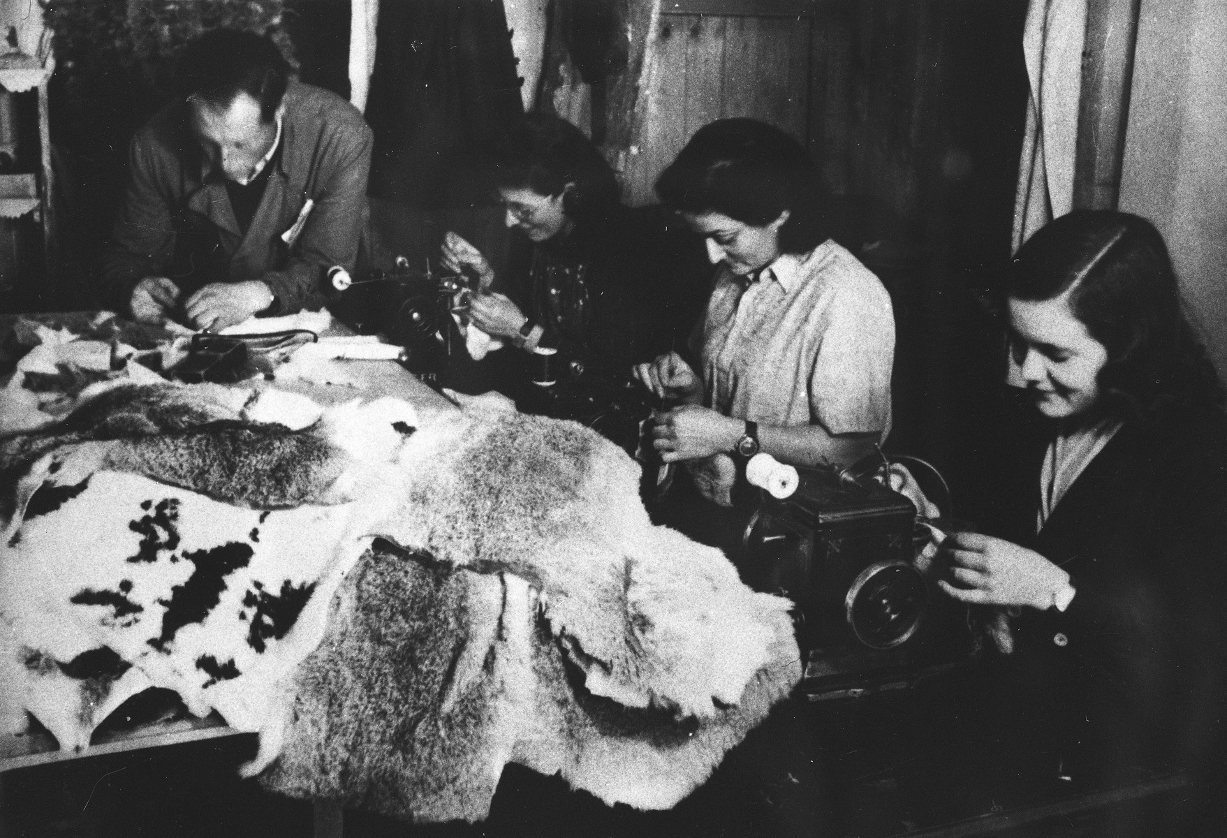 Prisoners sew coats from animal pelts at a Slovak labor camp.