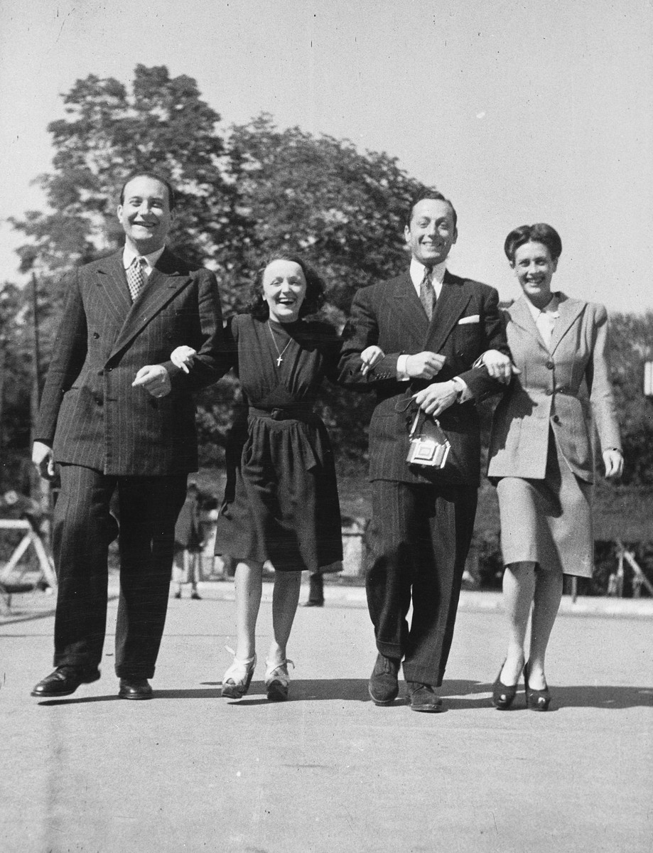 Four French performers dance across a street while on tour in Germany.

Edith Piaf is second from the left.  Sadie Rigal, who is actually a Jew in hiding, is on the right.  Next to Sadie is her dance partner, Frederic Apcar.