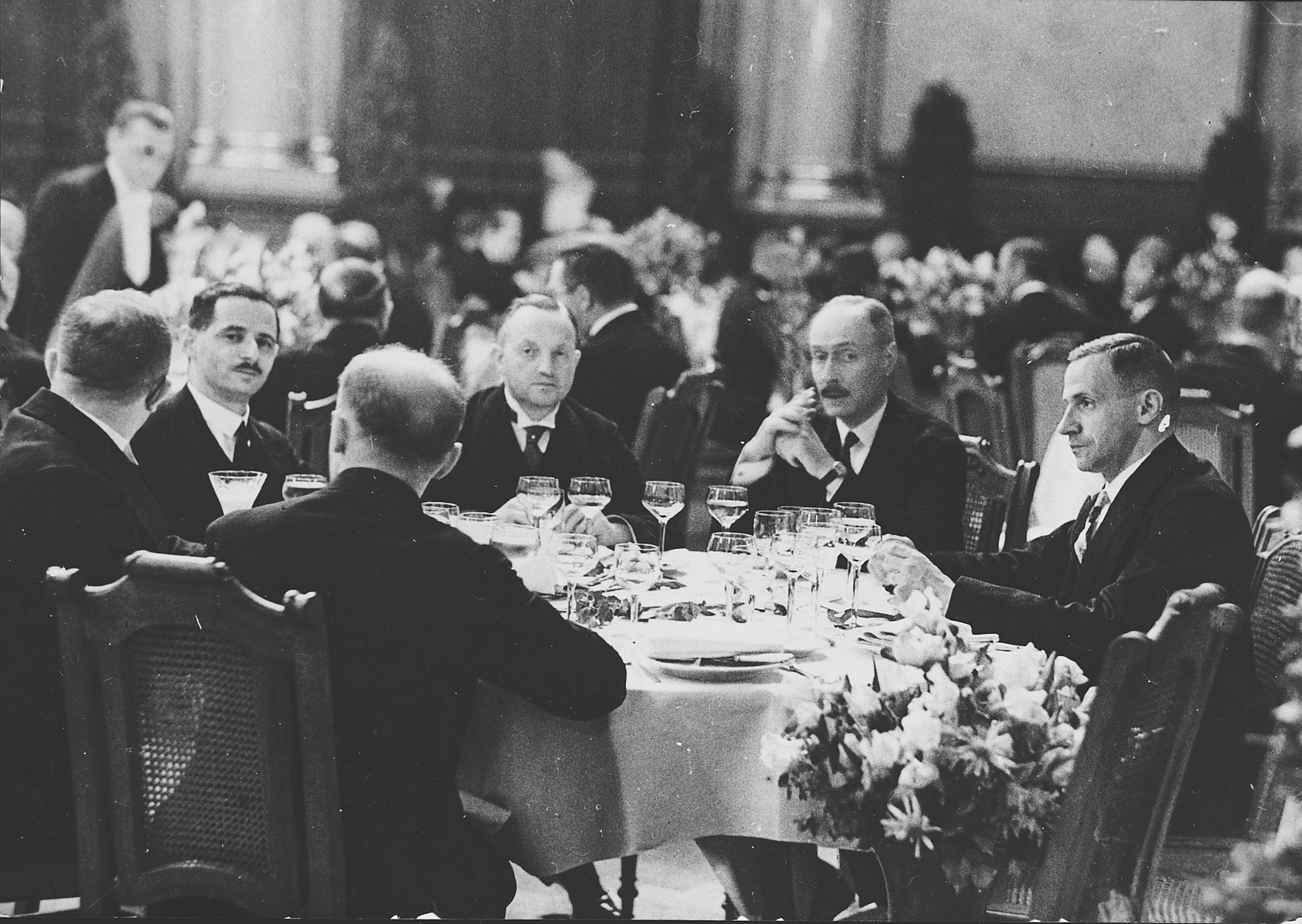 Guests sit at tables in the townhall banquet hall for a formal breakfast in honor of King Fouad of Egypt.

Among those pictured is Kurt Zielenziger (seated second from the left), press secretary to the mayor of Berlin.