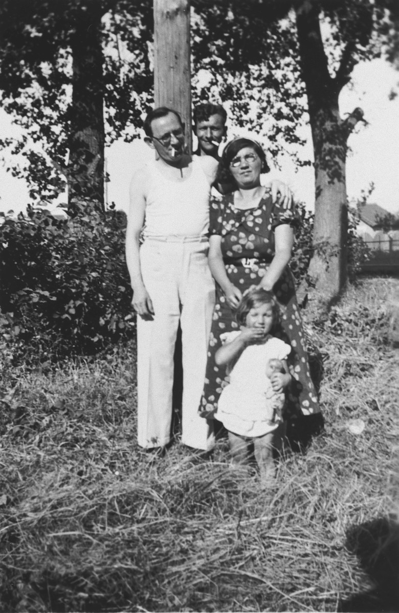 Polish-Jewish immigrants pose with their young daughter and a friend in a field near Paris.

Pictured are Sacha and Esther-Rachel Szenker and their daughter Paulette.