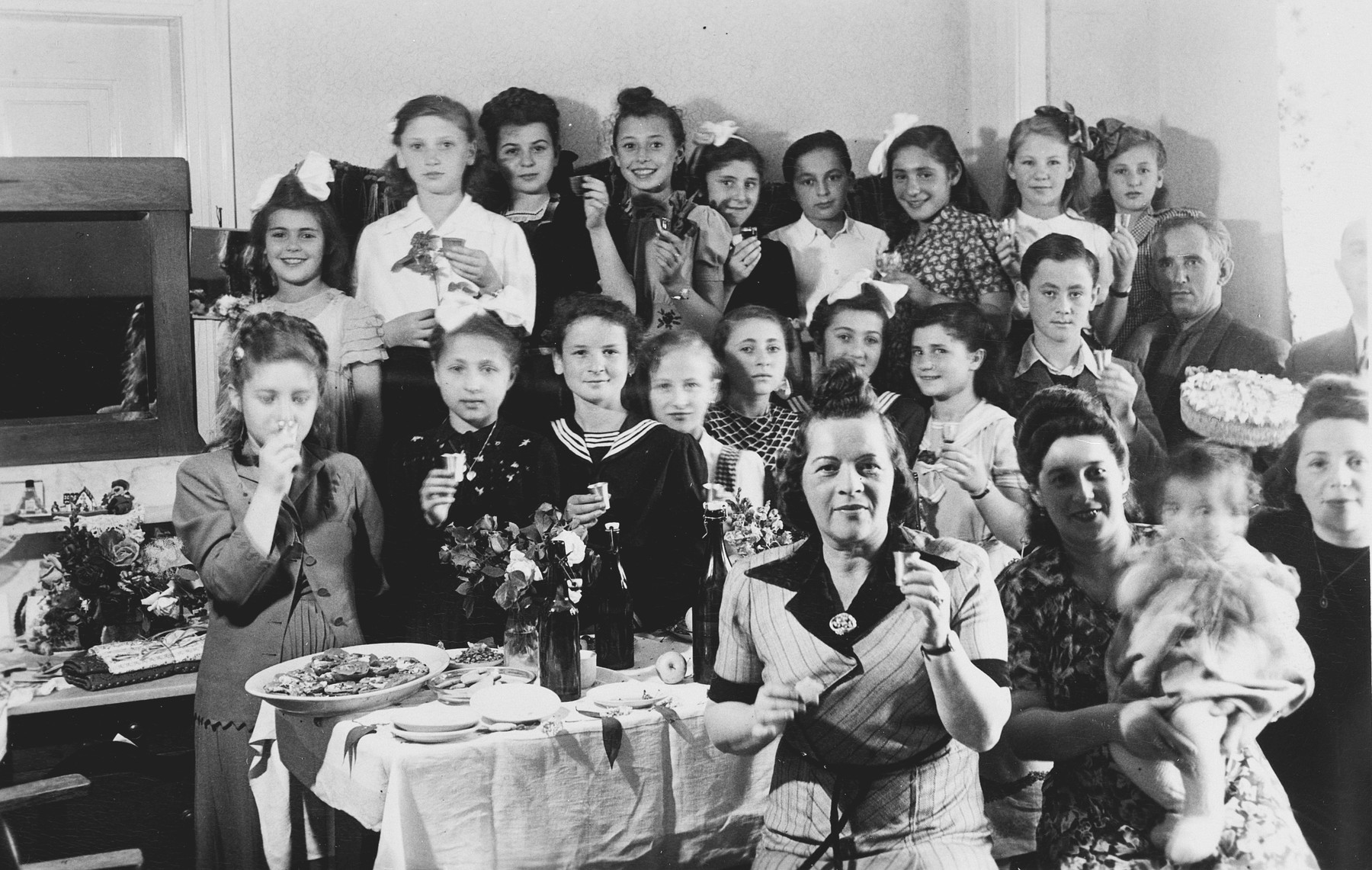 School children hold small silver cups during a celebration in the Stuttgart displaced persons camp.

Among those pictured in the middle row, Irka Hechtkopf, second from the left; Rywka Weinberg, fourth from the left; Hela Huberman, seventh from the left and Lova Warszayczyk (the donor), second from the right.
