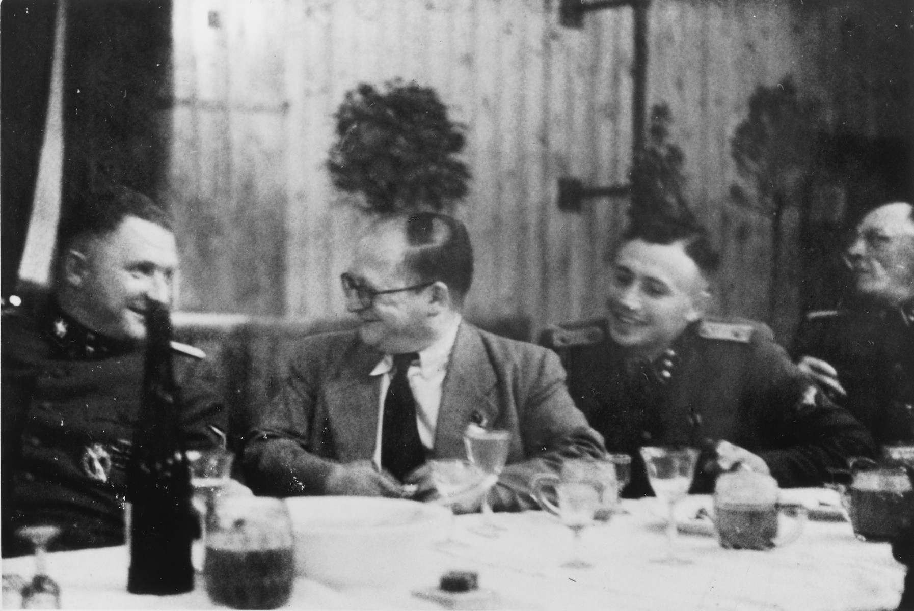 SS officers gather for drinks following the dedication of the new SS hospital in Auschwitz.

Pictured from left to right Richard Baer, Dr. Carl Clauberg, Karl Hoecker, and Heinrich Josten.