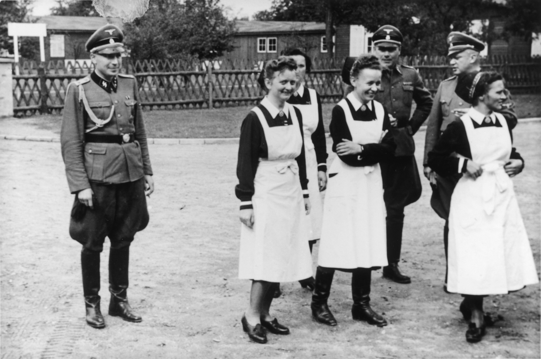 SS officers and German nurses gather during the dedication ceremony of the new SS hospital in Auschwitz.

Among those pictured are Karl Hoecker, Josef Kramer and SS-Hauptsturmfuhrer Heinrich Schwarz.  Among the nurses probably are Martha Mzyk and Lotte Nitschke.